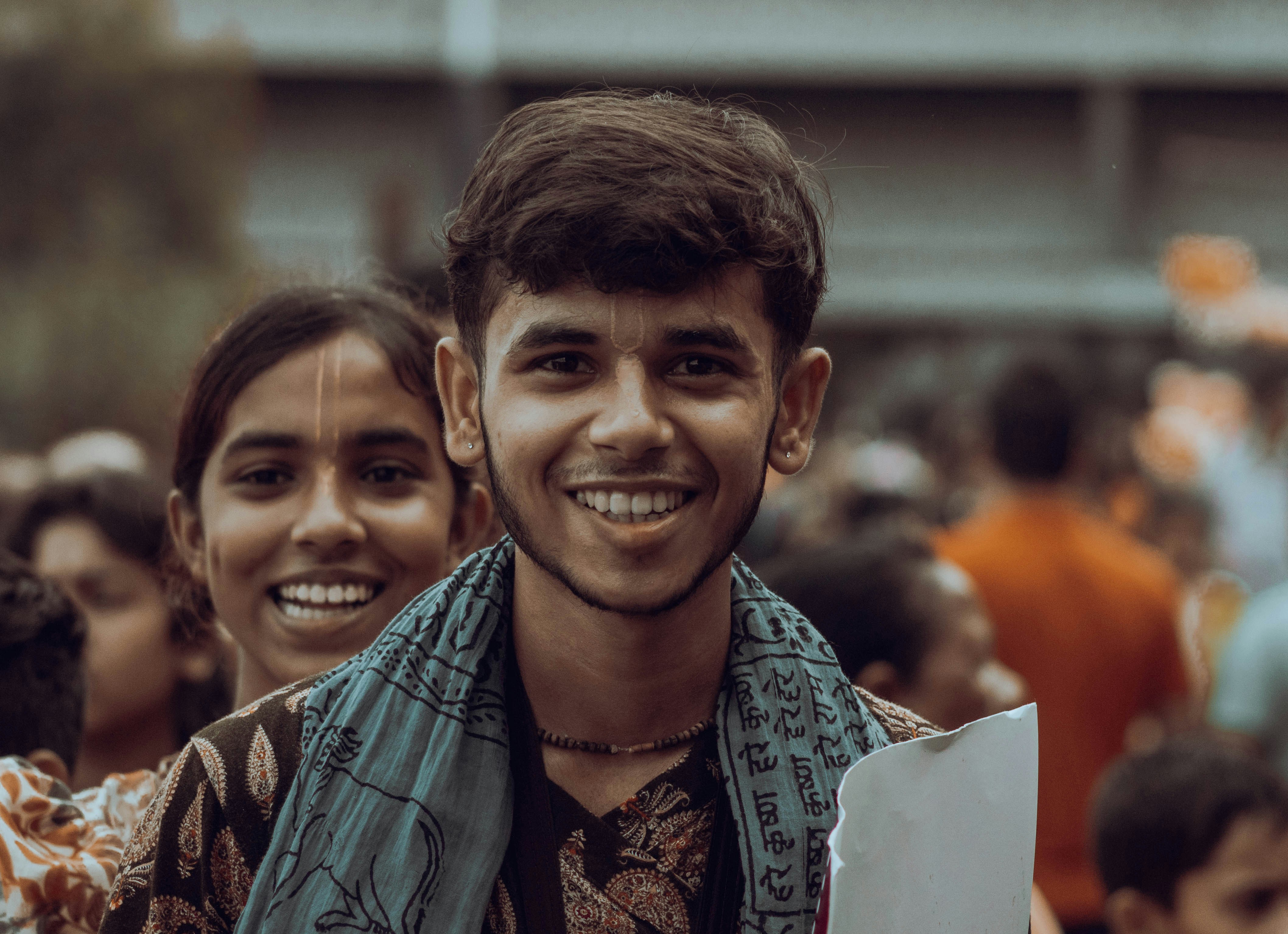 A student showing their camera screen with a perfectly exposed photo to the instructor, smiling