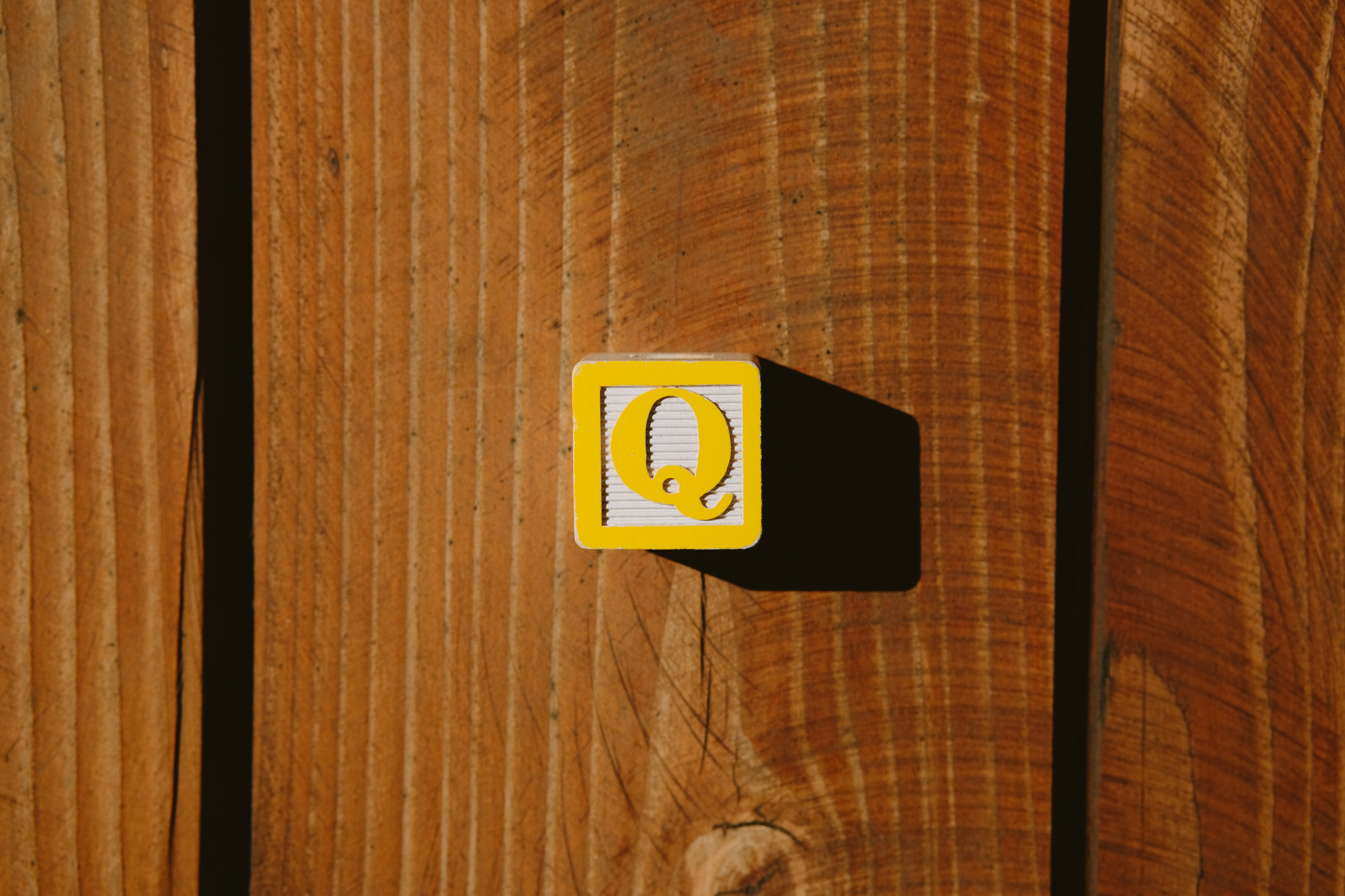 Close up of a smartphone scanning a QR code on a wooden sign