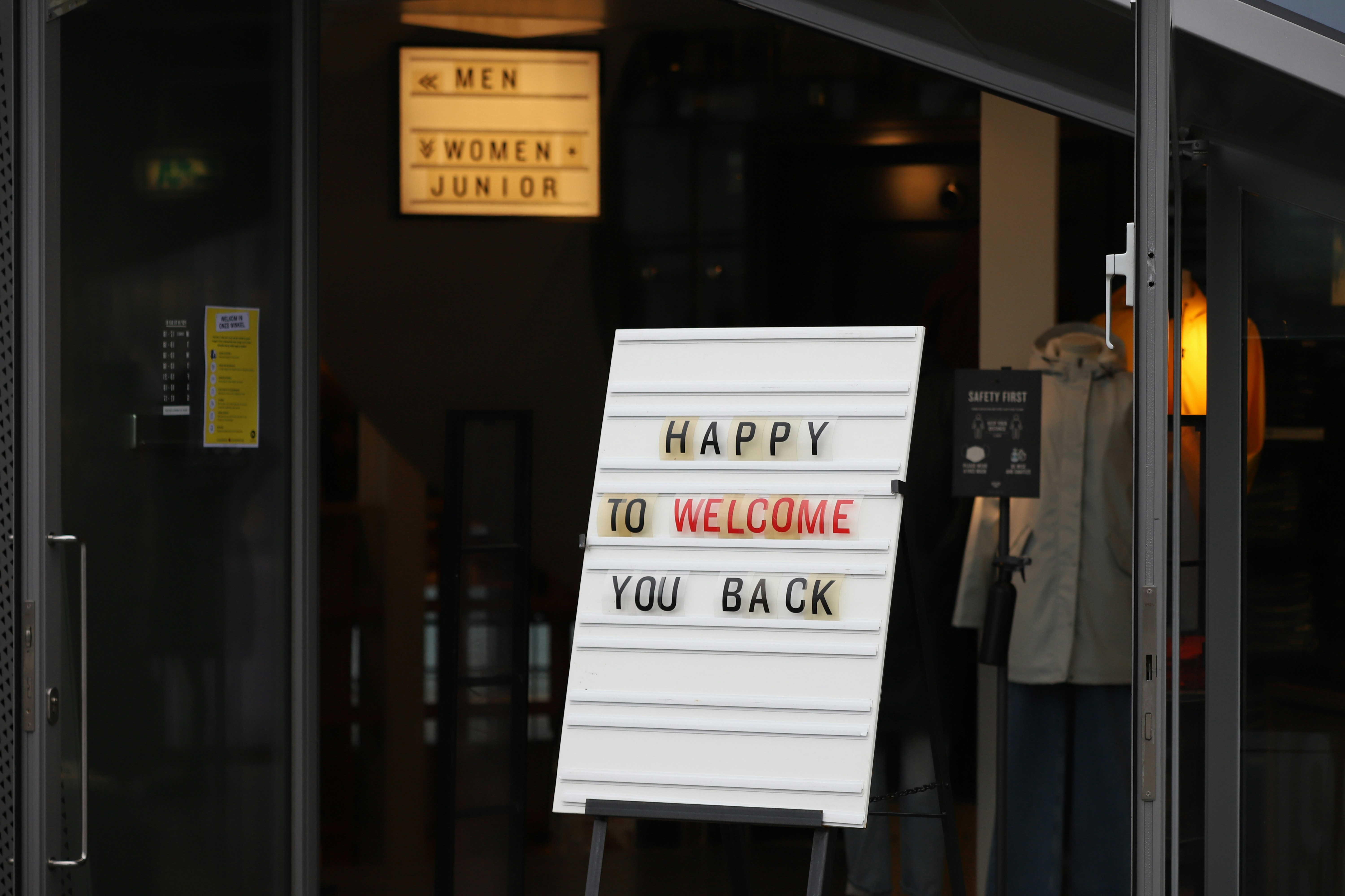 Business owner looking happy while looking at tablet screen in a cafe