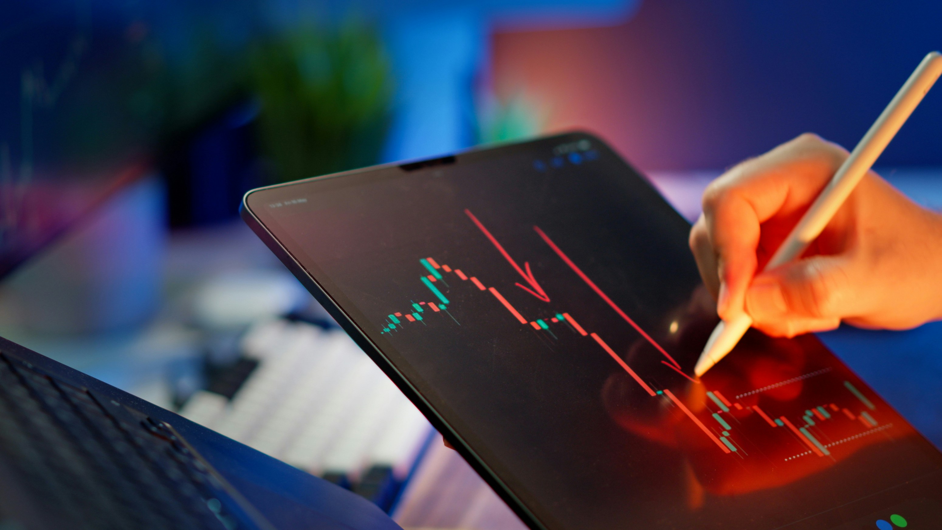 Close-up of a laptop screen showing a financial growth chart with green indicators