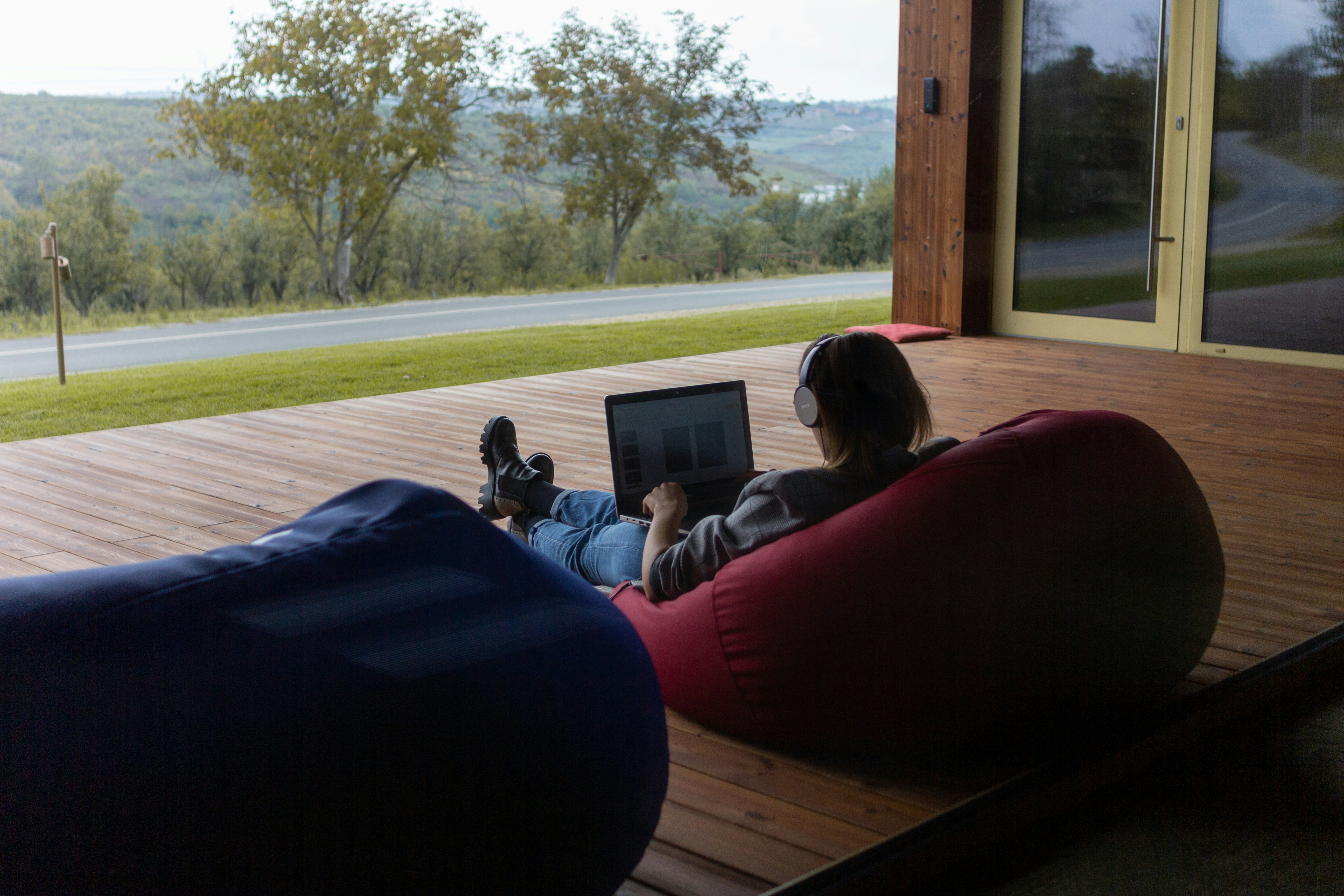 A digital nomad working on a tablet in a hammock, showcasing the ease of mobile website management