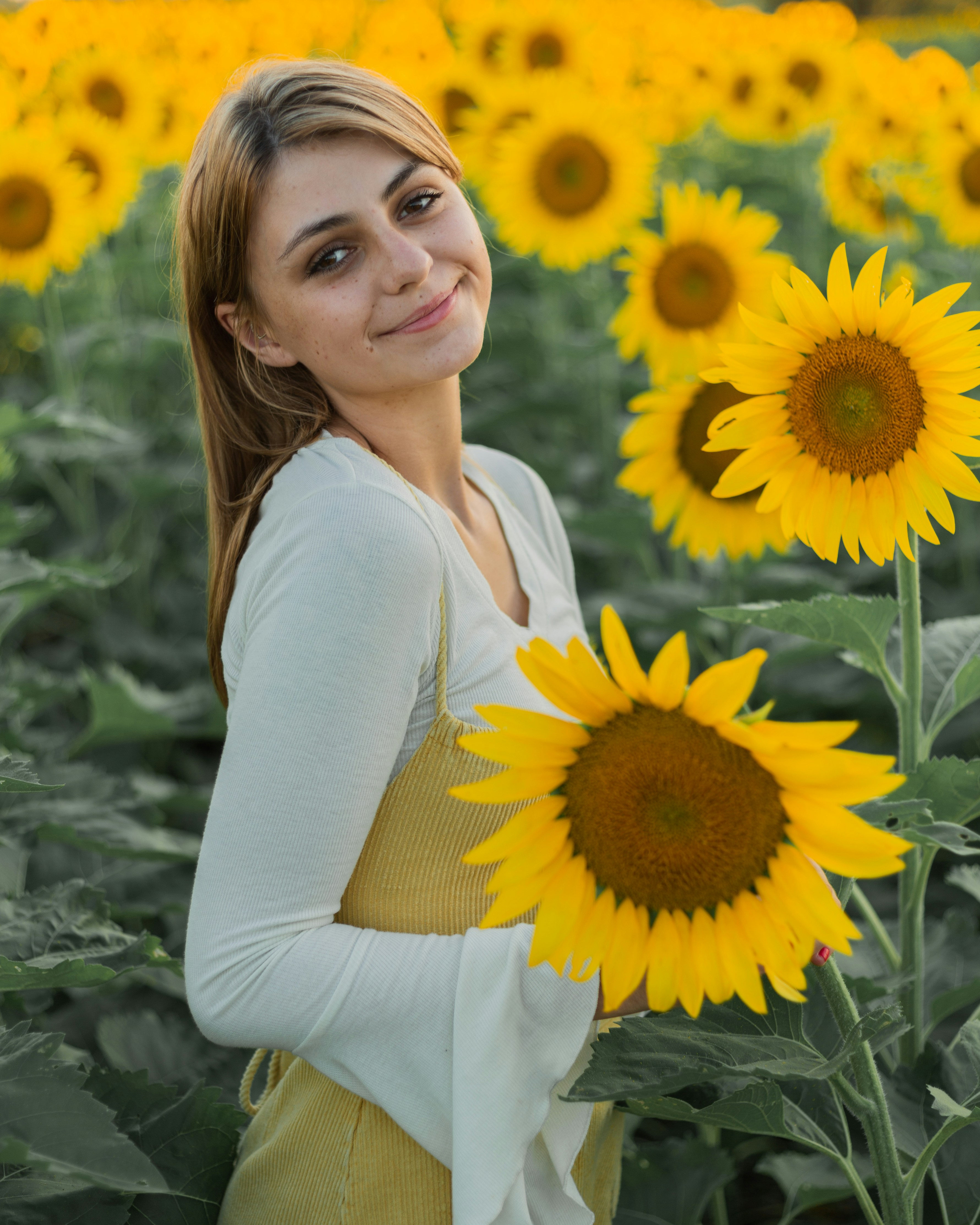 Close up portrait of a confident business woman smiling with soft natural lighting and neutral background