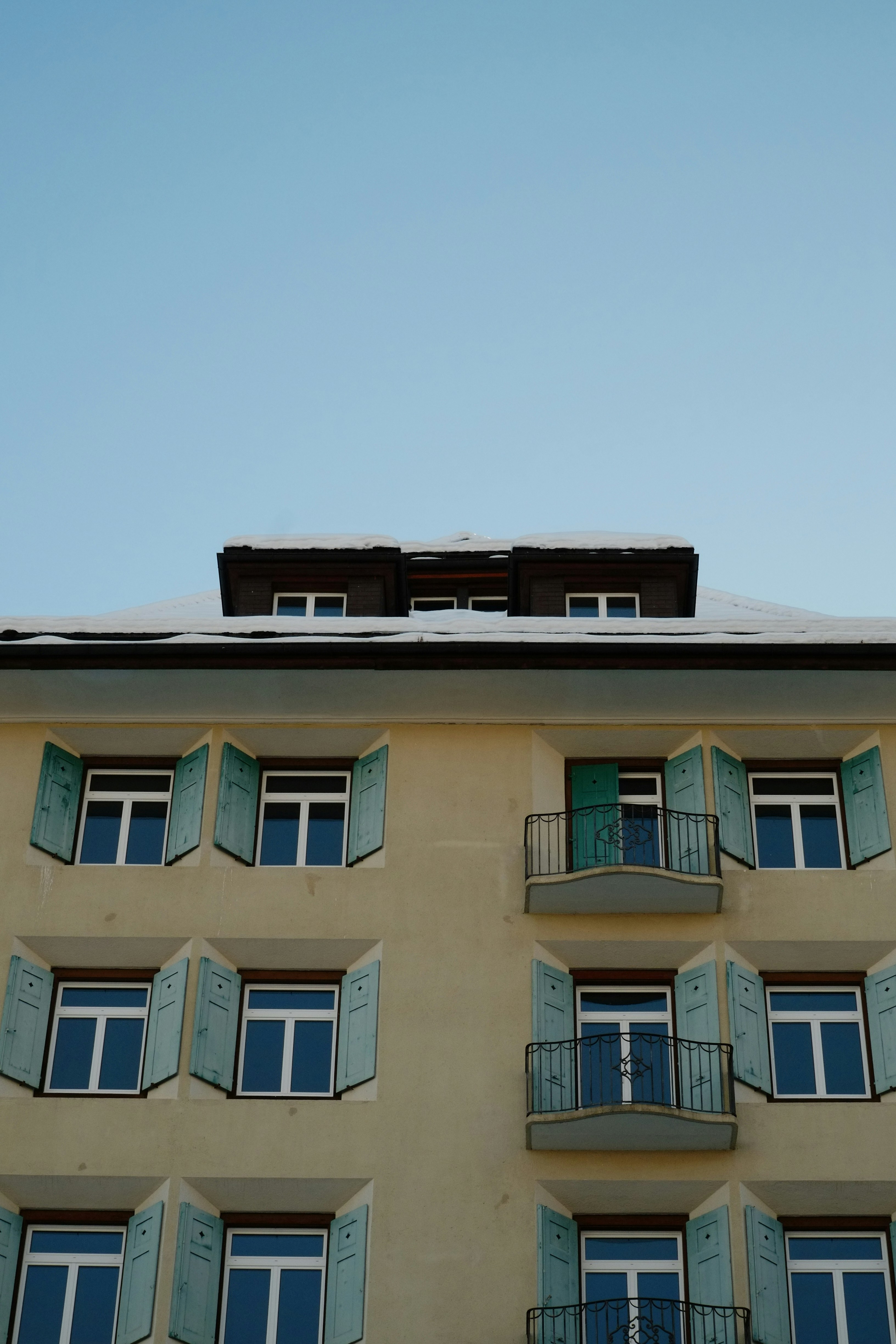 Professional engaging in facade renovation applying external insulation on a swiss building