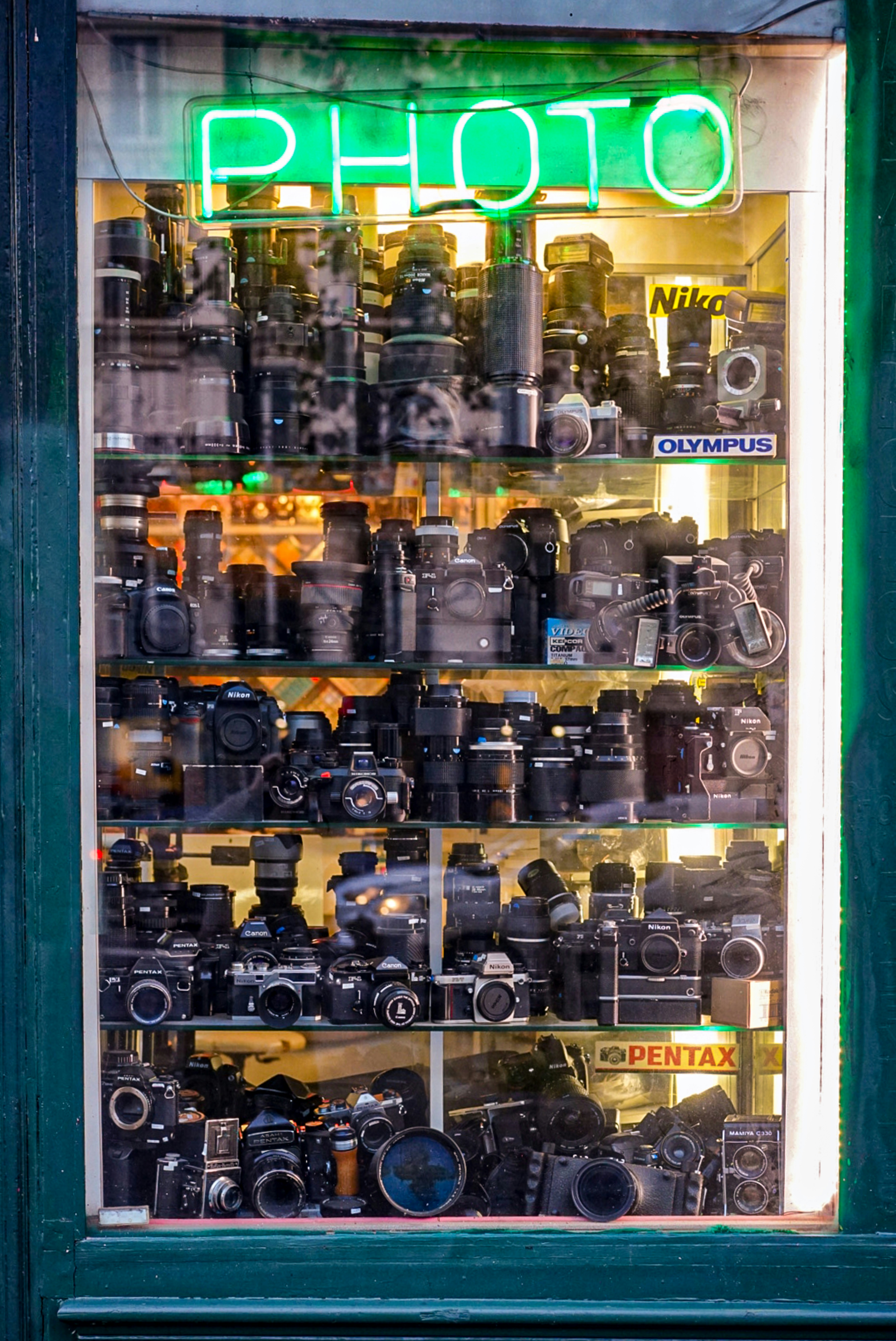 Close up of a camera lens focusing on a retail store window display