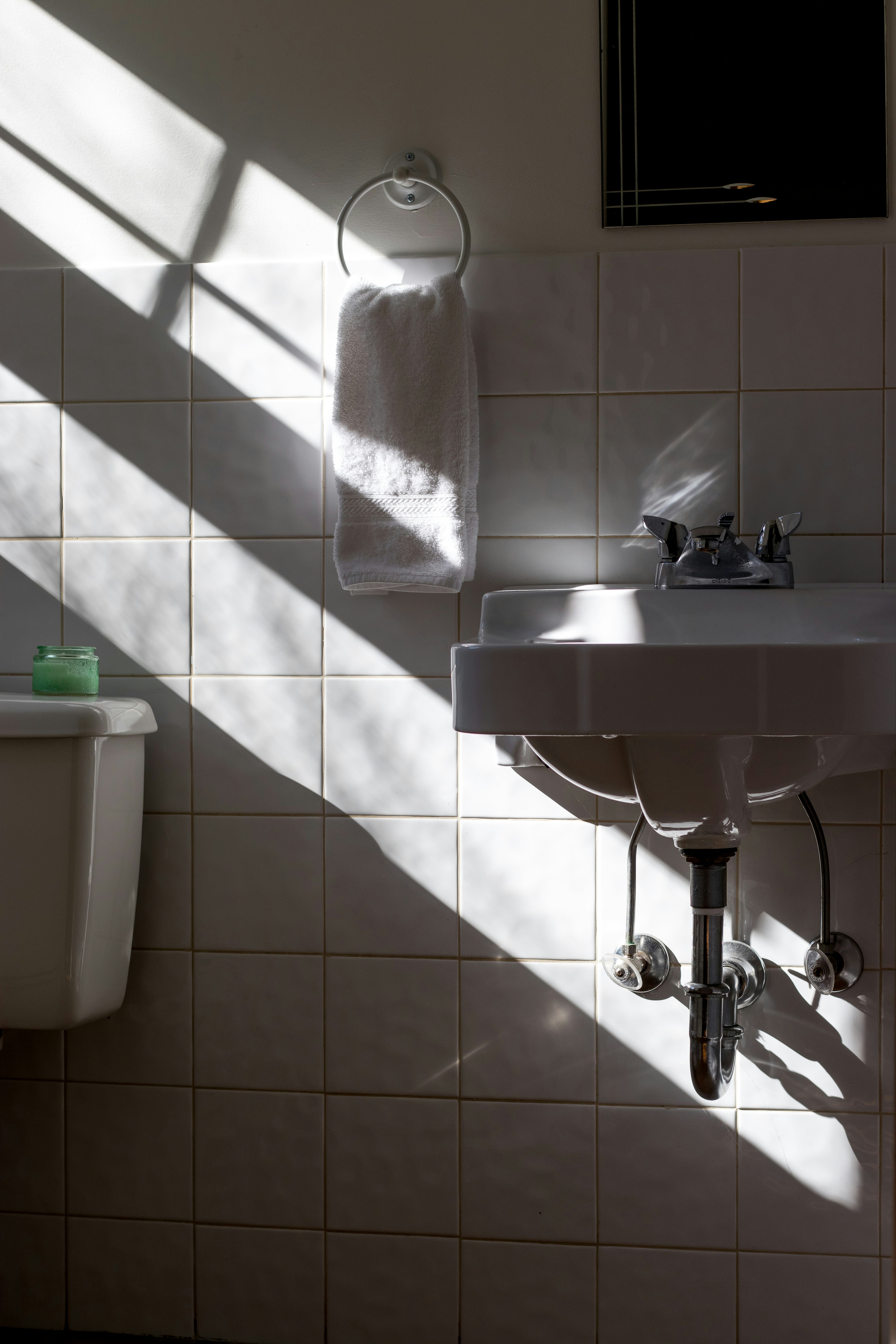 Close up of hands installing a modern faucet in a bathroom renovation