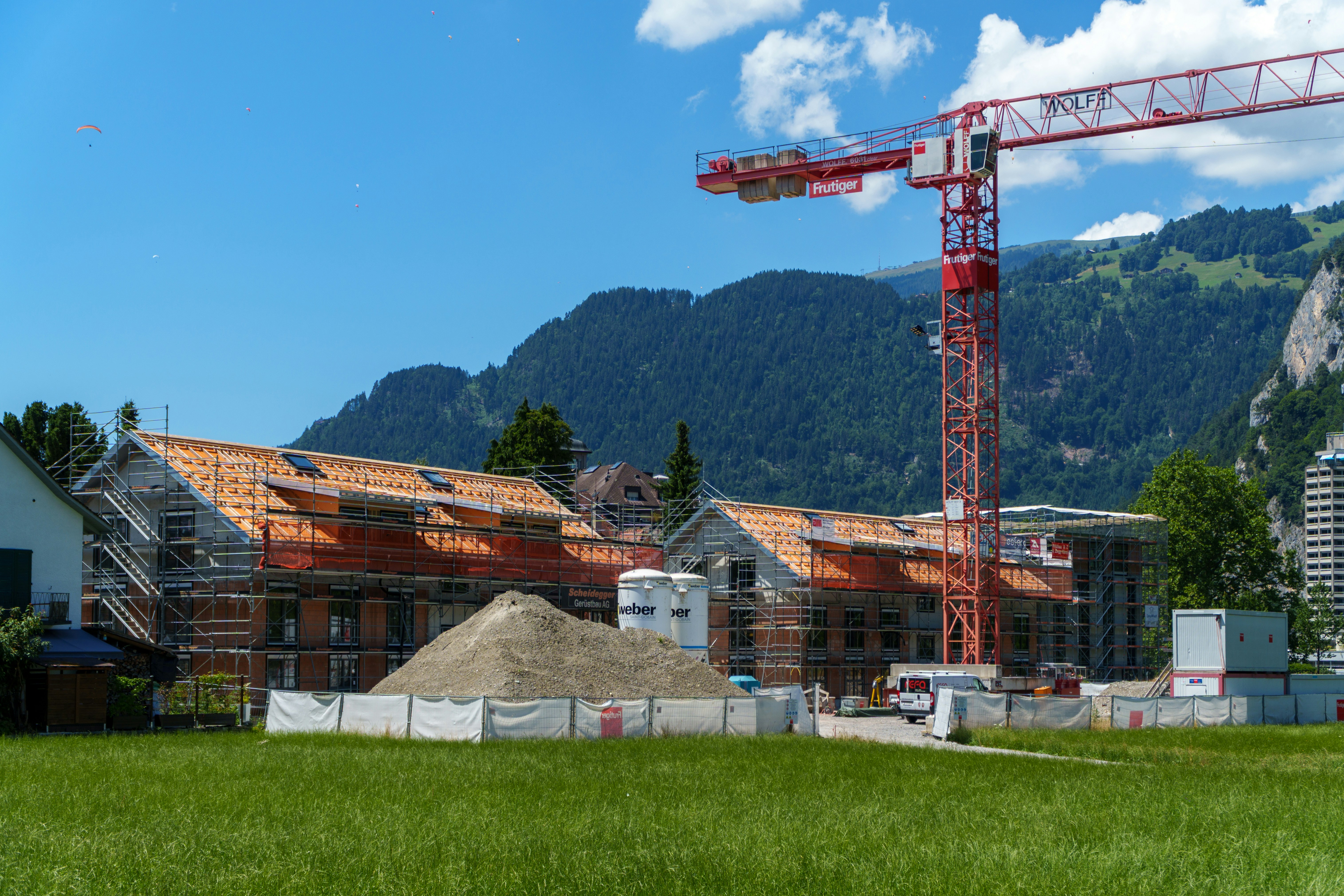 Construction site of a modern new house in Switzerland with crane and concrete structure