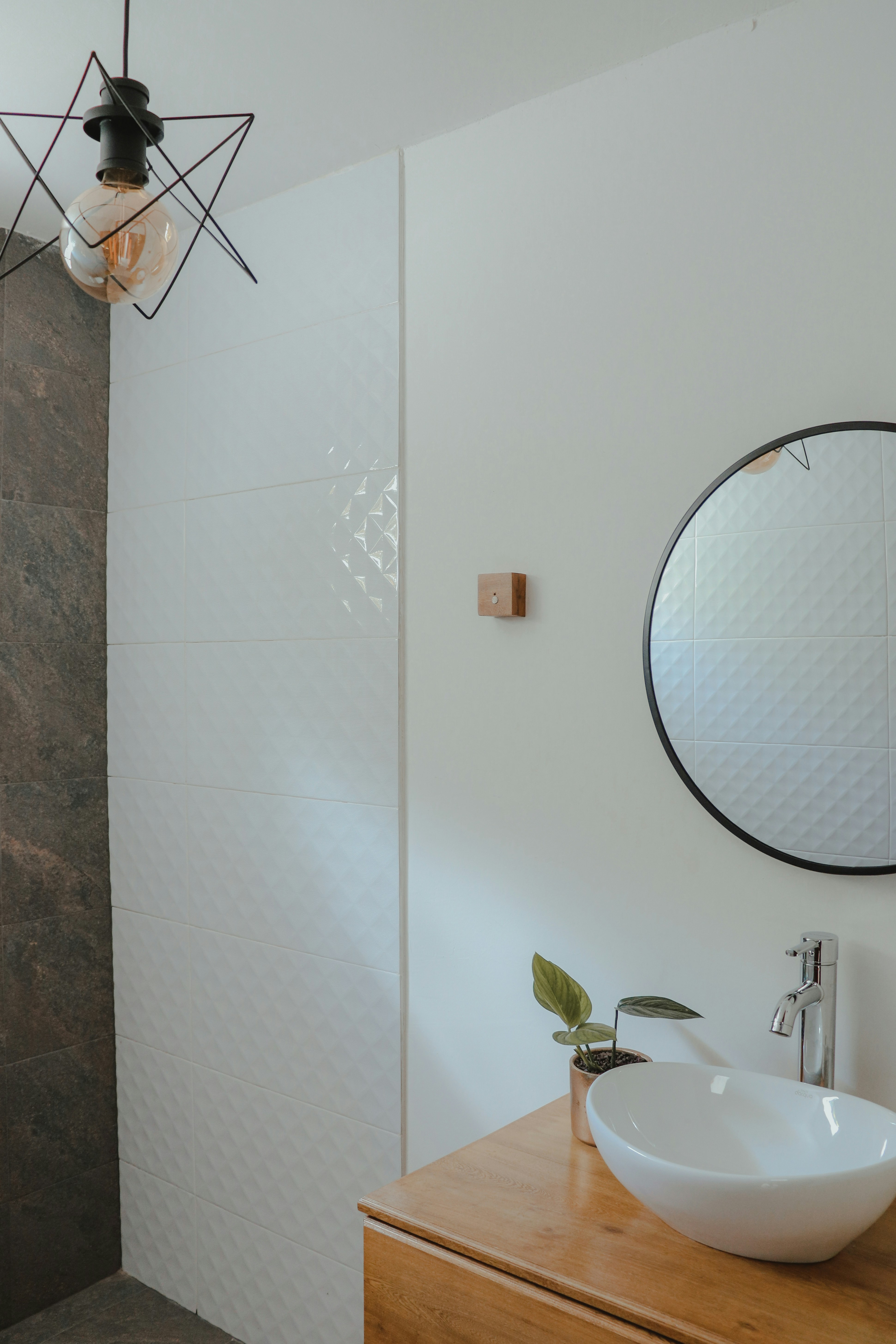 Modern minimalist bathroom renovation with white tiles and copper fixtures