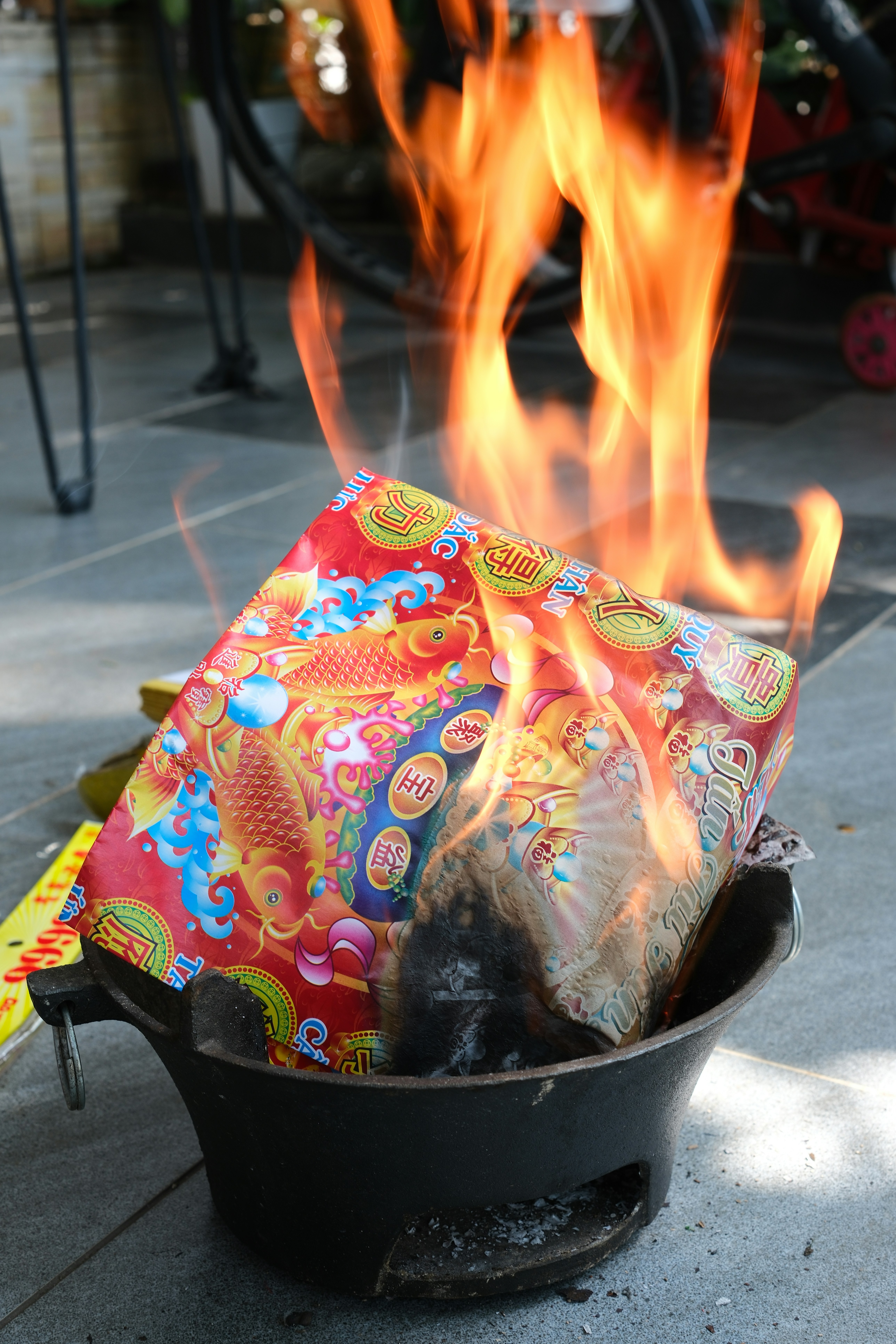 Close-up of burning sage bundle with smoke rising, natural light, hands holding it gently based on cleansing rituals.