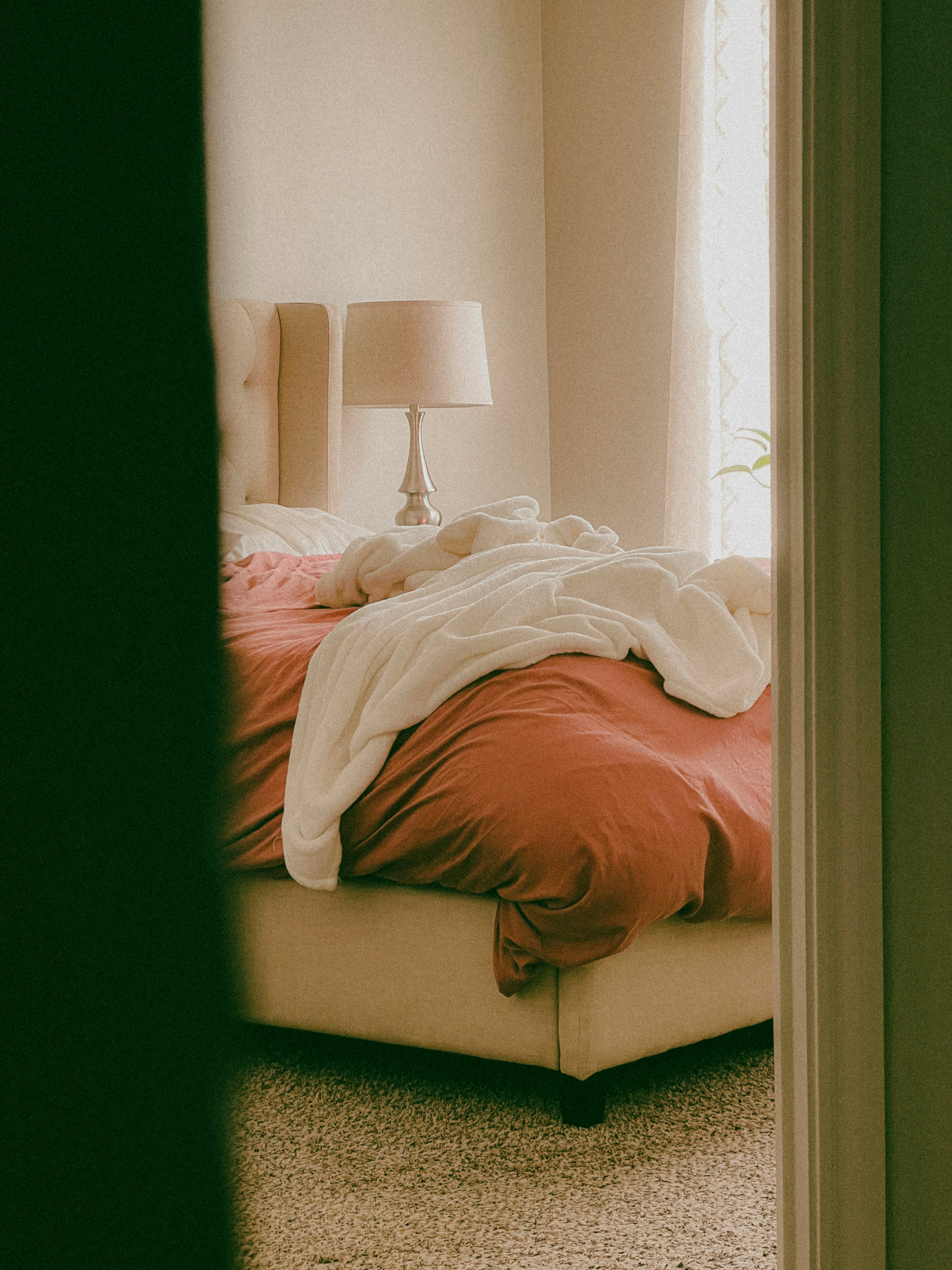 Clean master bedroom with white bedding prepared for a photo shoot
