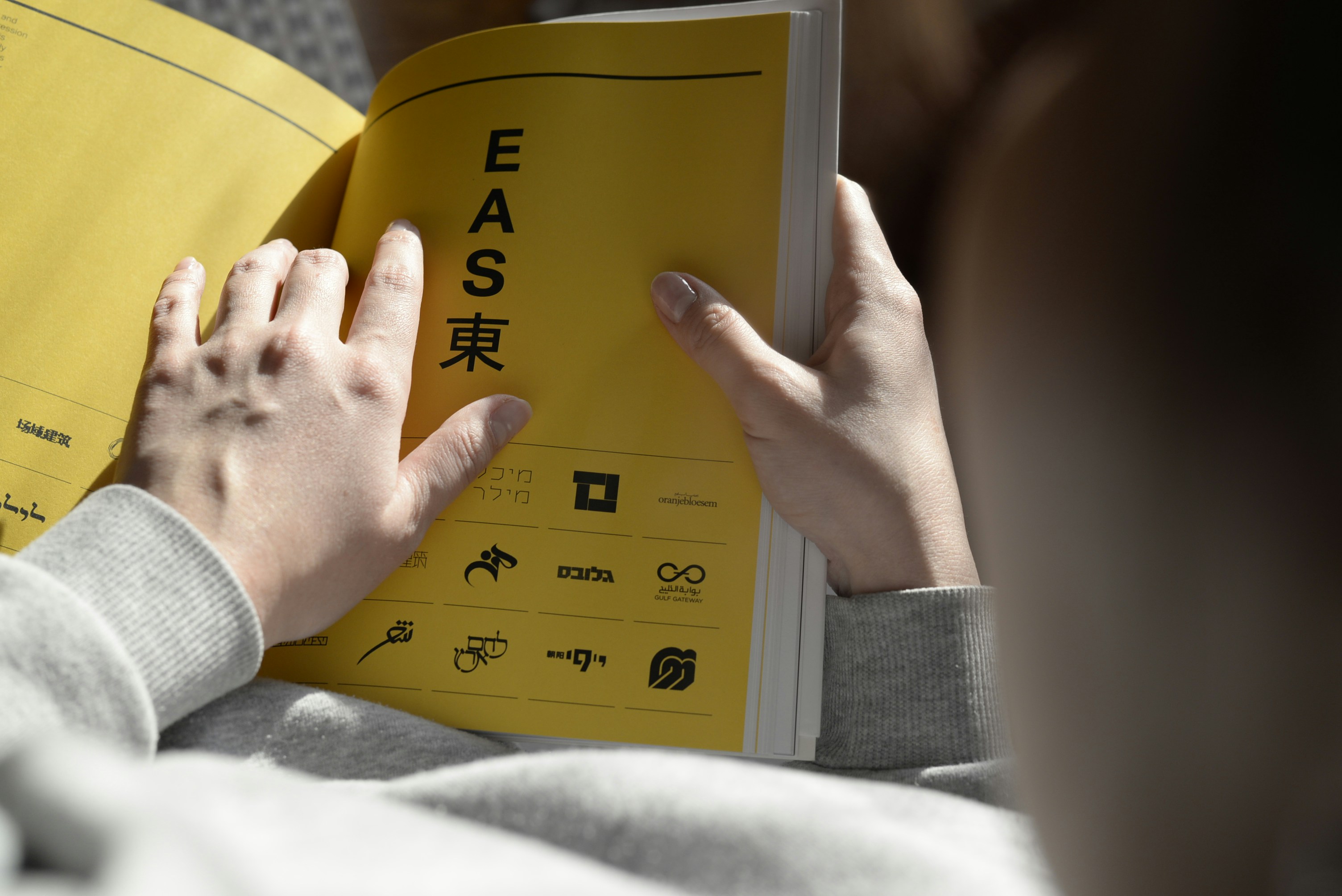 Close-up of hands holding a book open, conveying focus and deep learning.