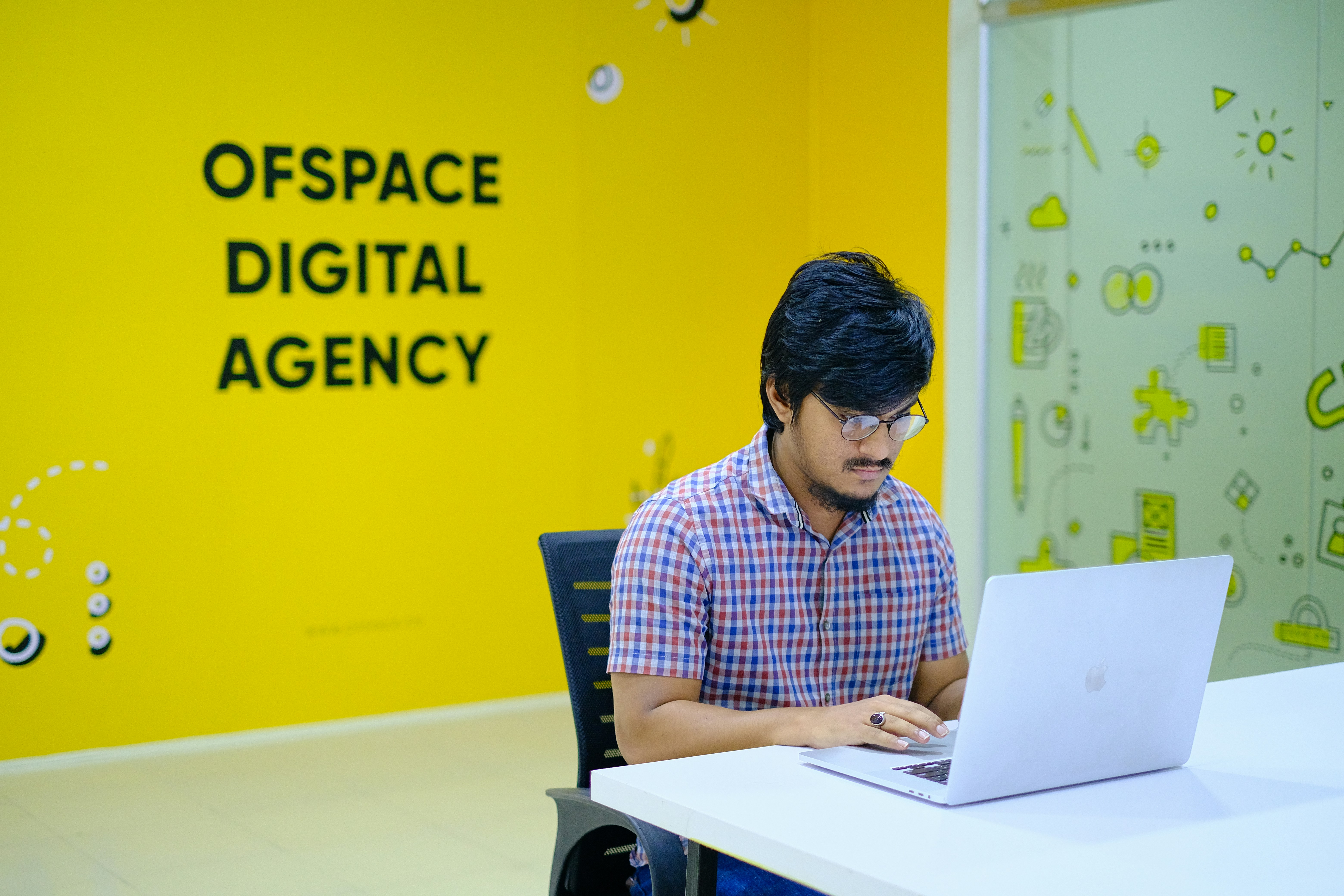 A digital entrepreneur analyzing data on multiple screens in a modern swiss office setting