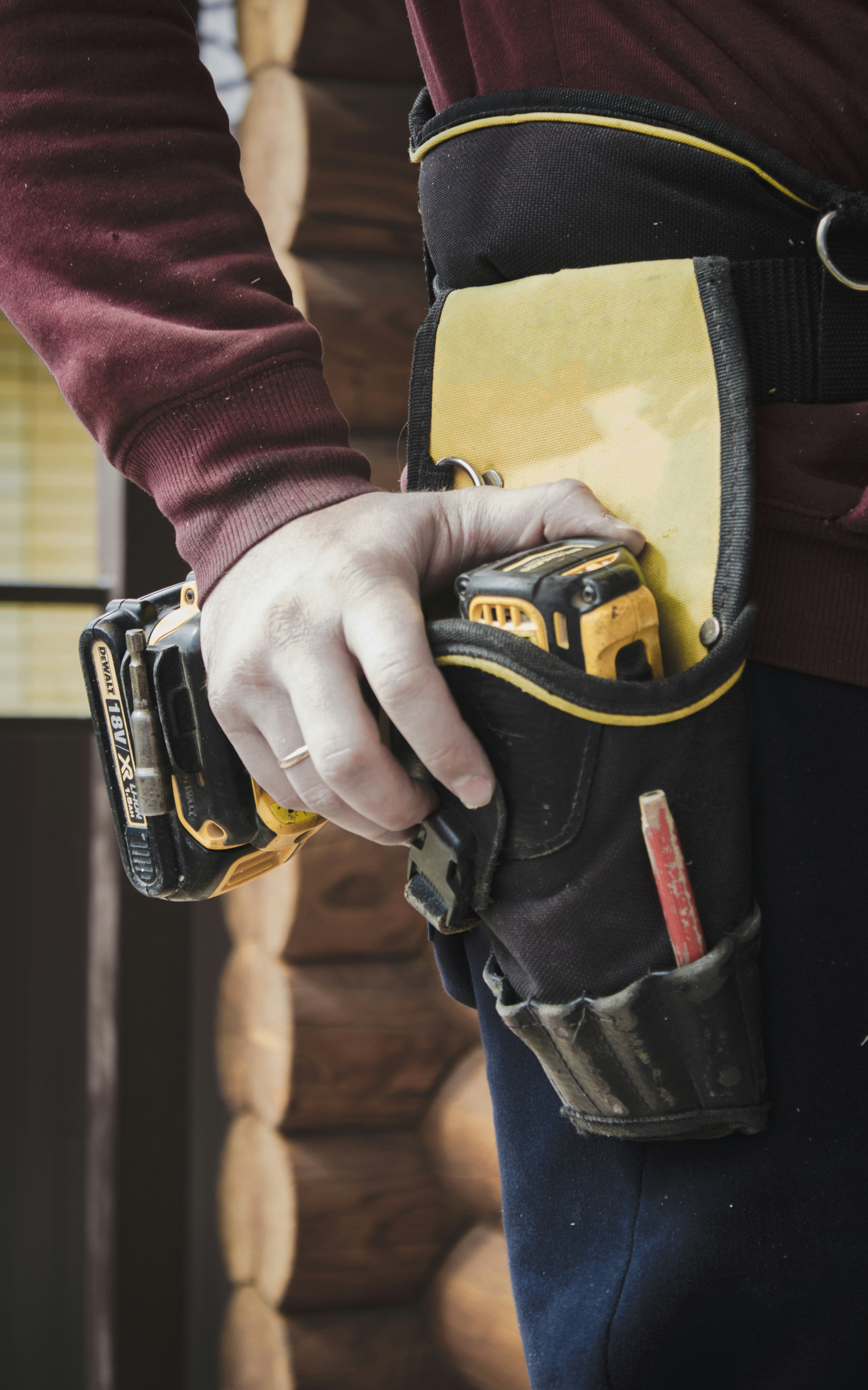 Close up of a construction worker hands holding a heavy duty breaker tool with safety gloves