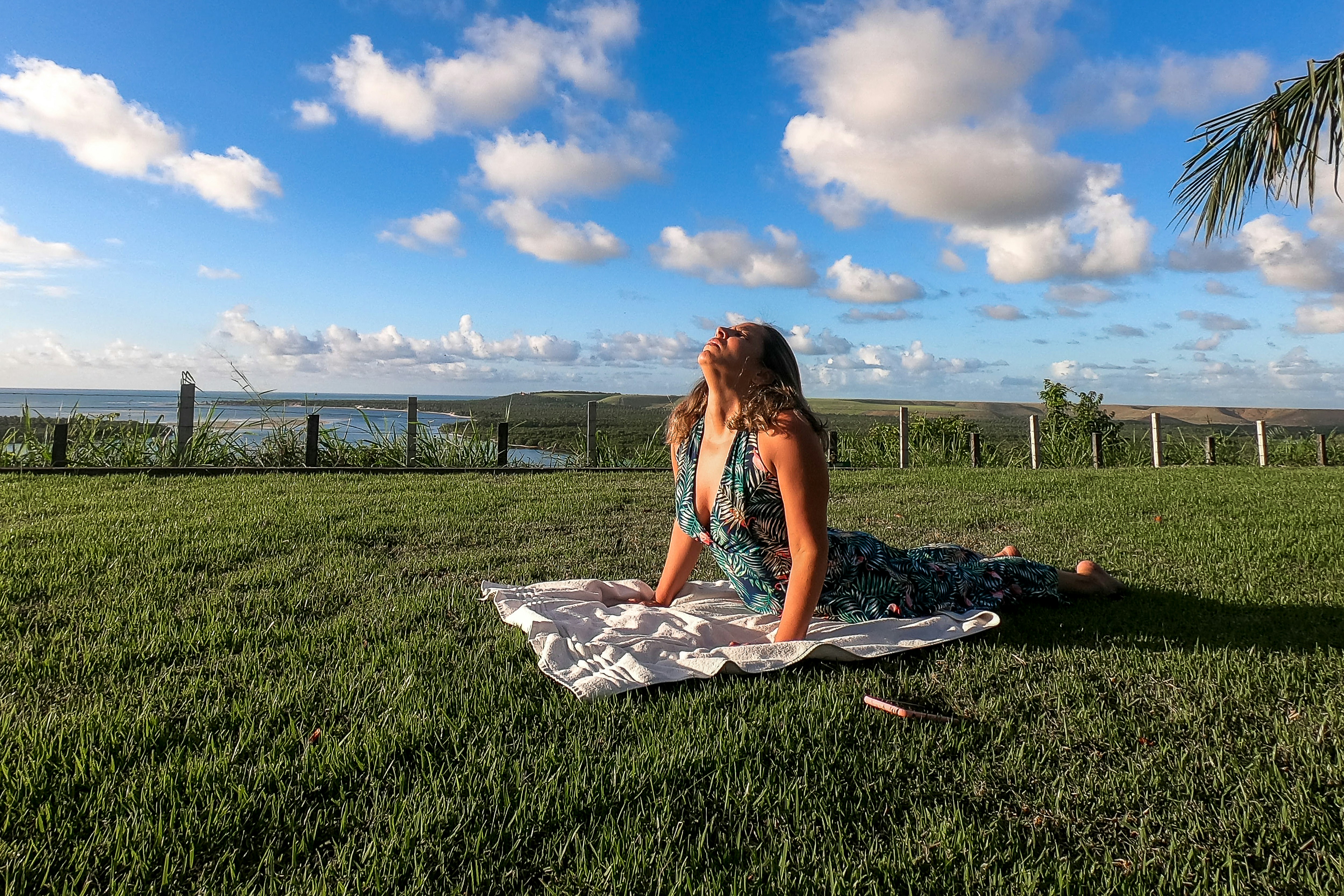 Person practicing gentle yoga outdoors in a peaceful park setting focusing on breathing