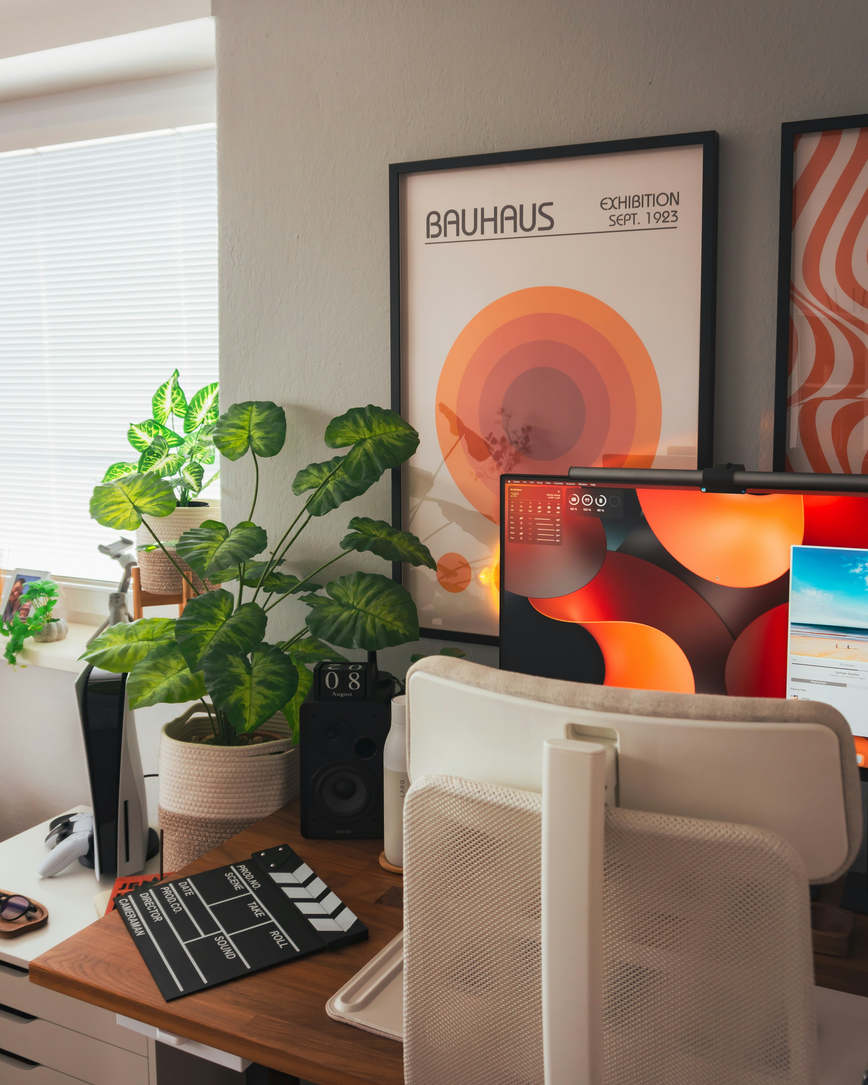 Clean modern home office setup with laptop showing a website builder interface warm lighting