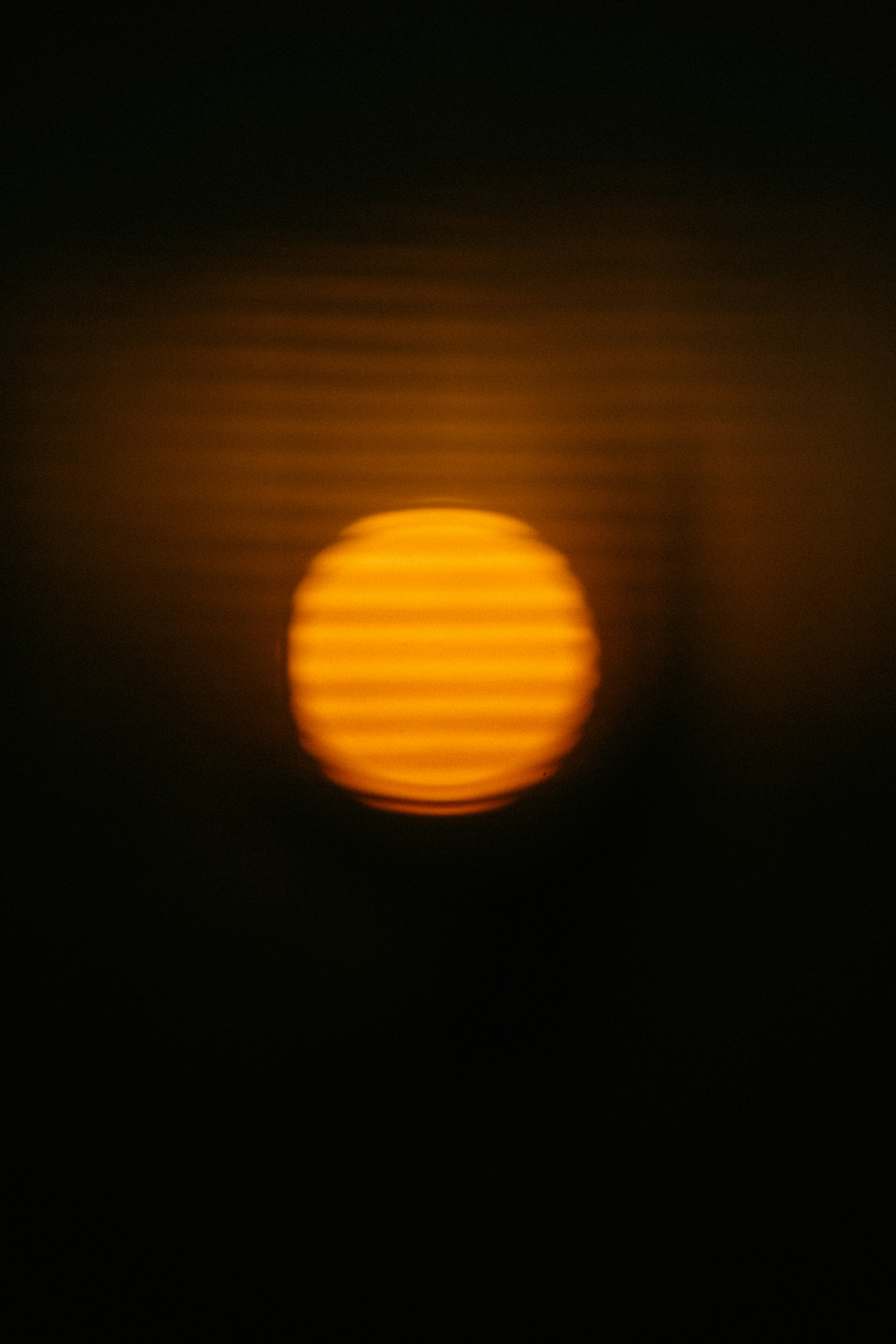 Close up of a professional camera lens focusing on a subject