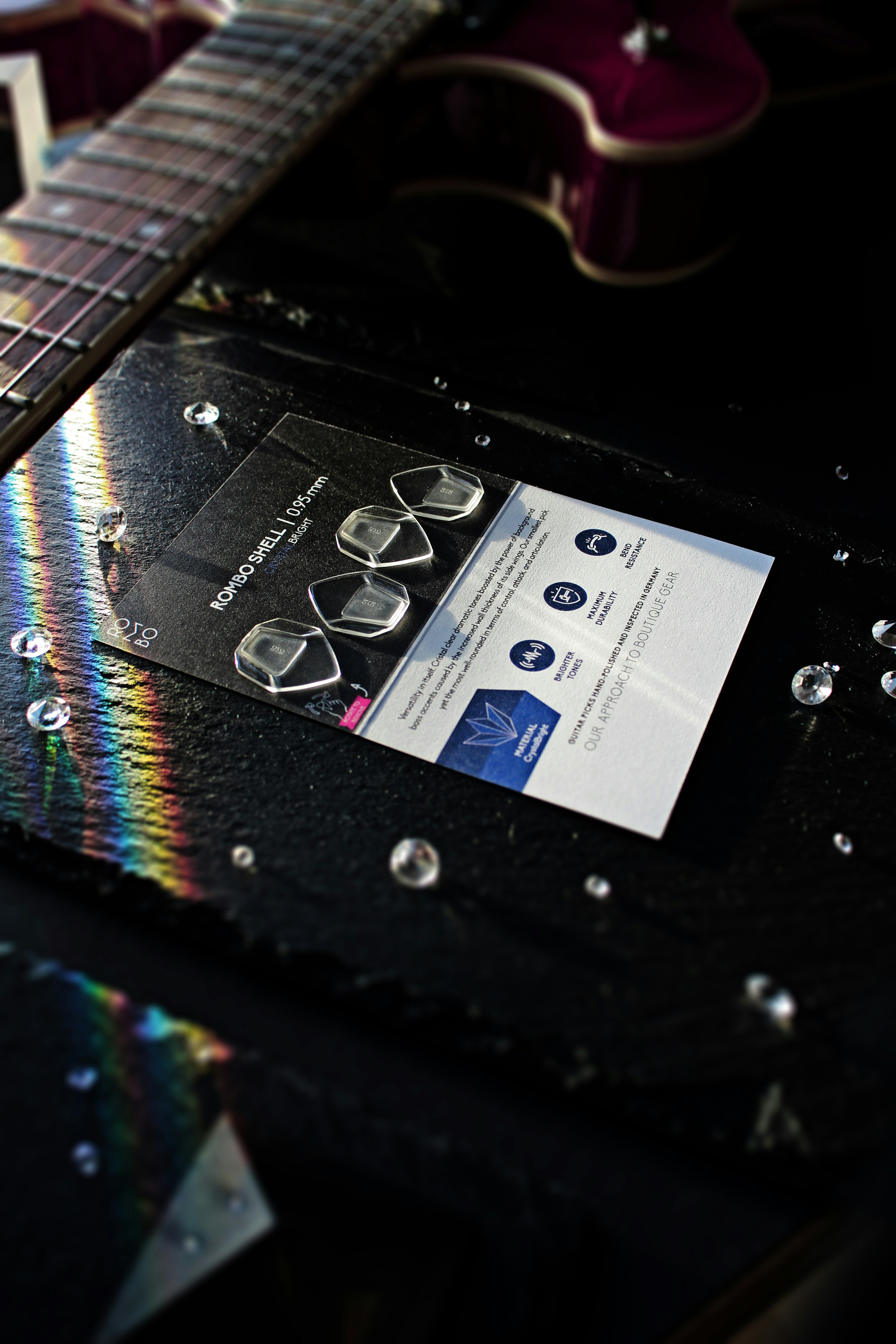 A close up photo of a smartphone scanning a QR code on a sticker plastered on a worn guitar case.