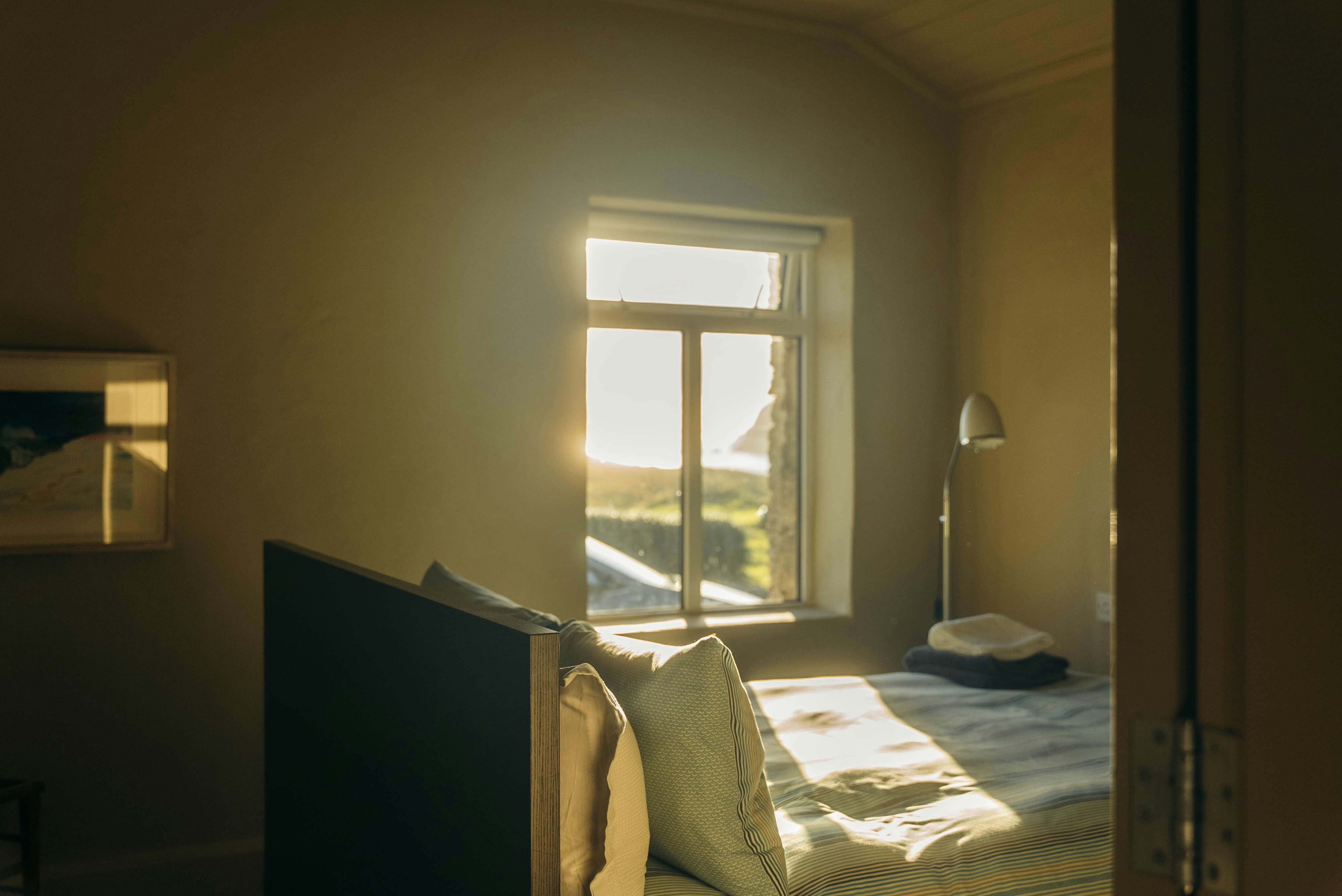 Minimalist modern living room with perfectly smooth grey walls and sunlight revealing the texture quality