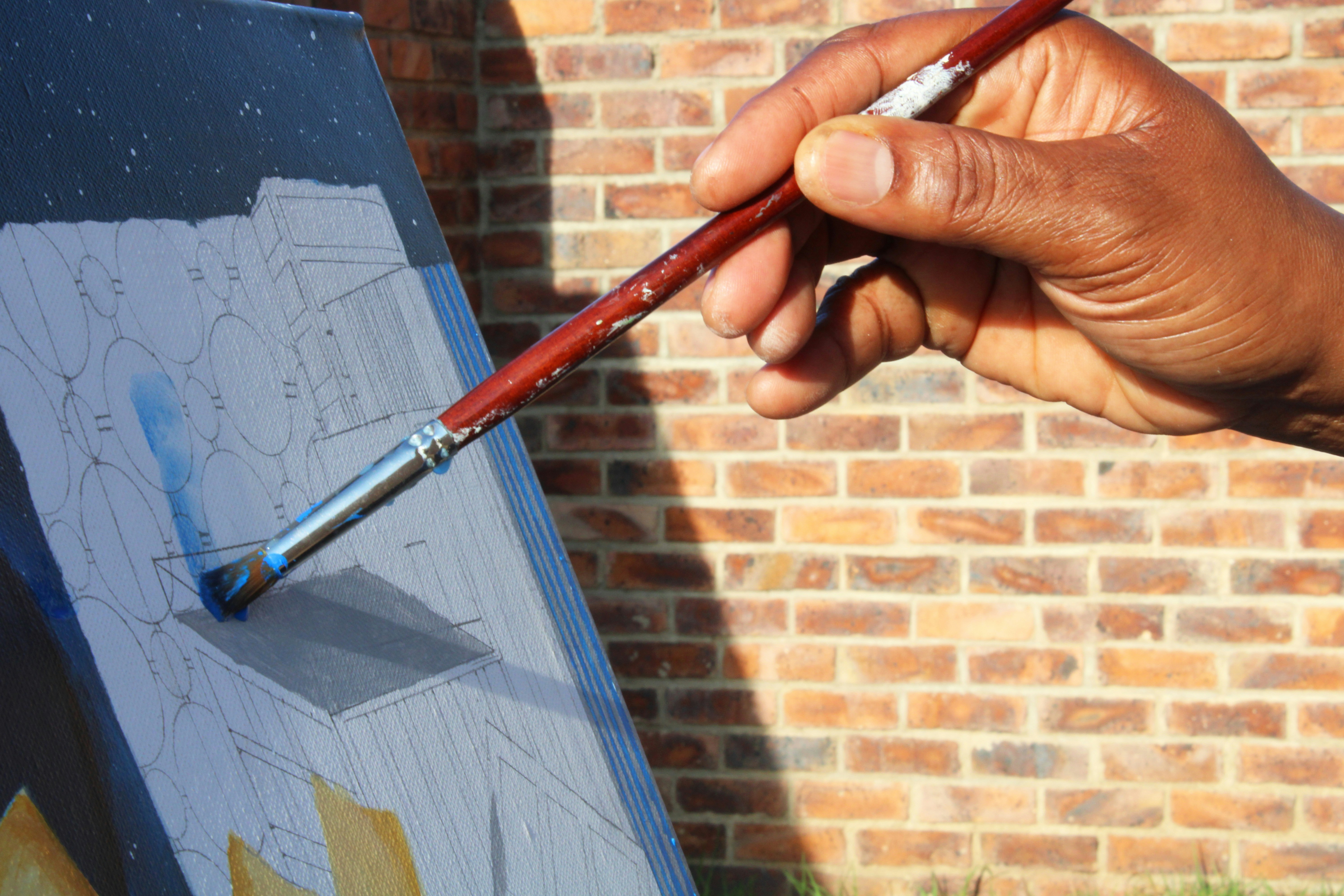 Professional painter applying white paint on a wall with precision using a roller