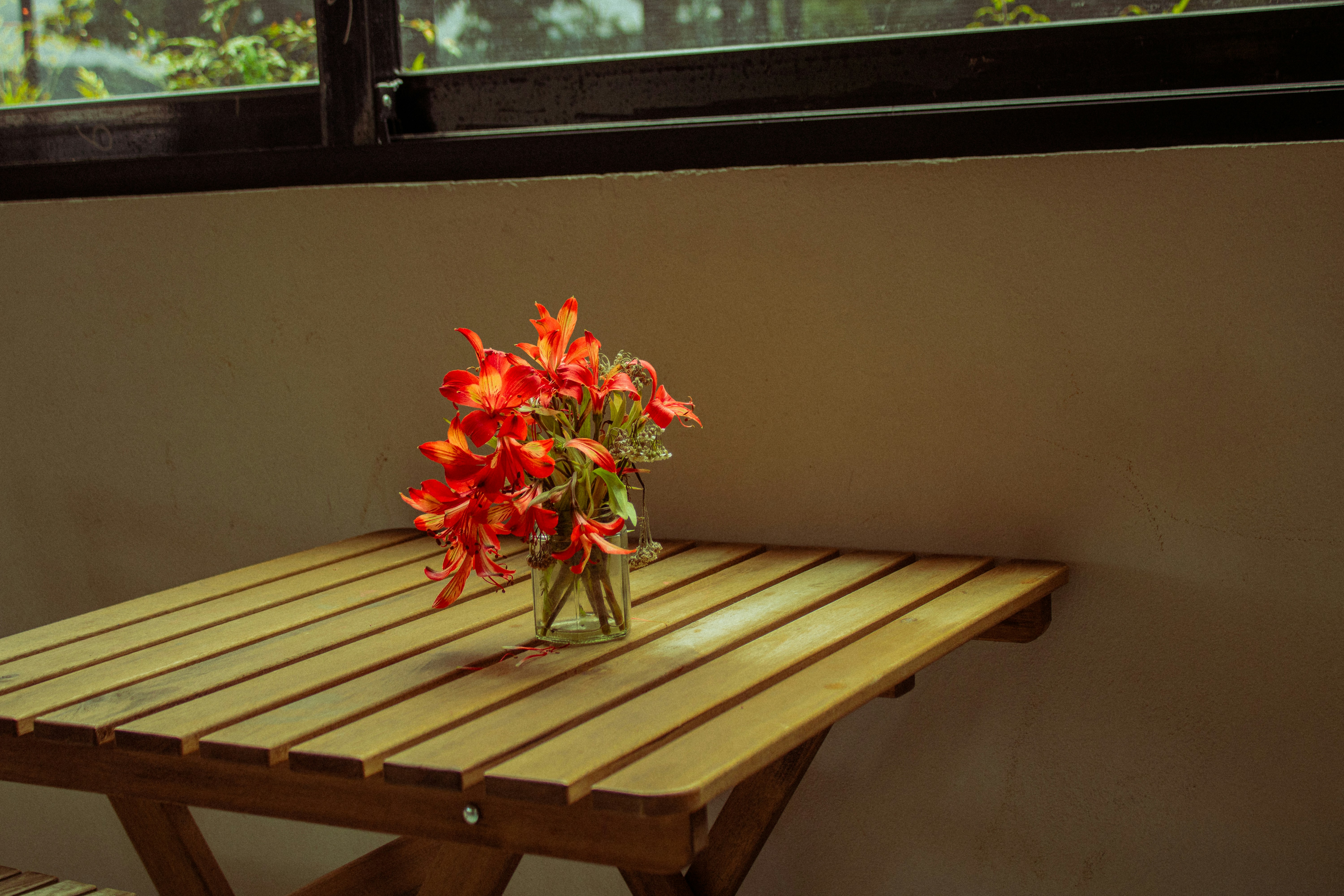 A flat lay photography of sustainable linen clothes on a wooden table, soft neutral colors, aesthetic arrangement with dried flowers