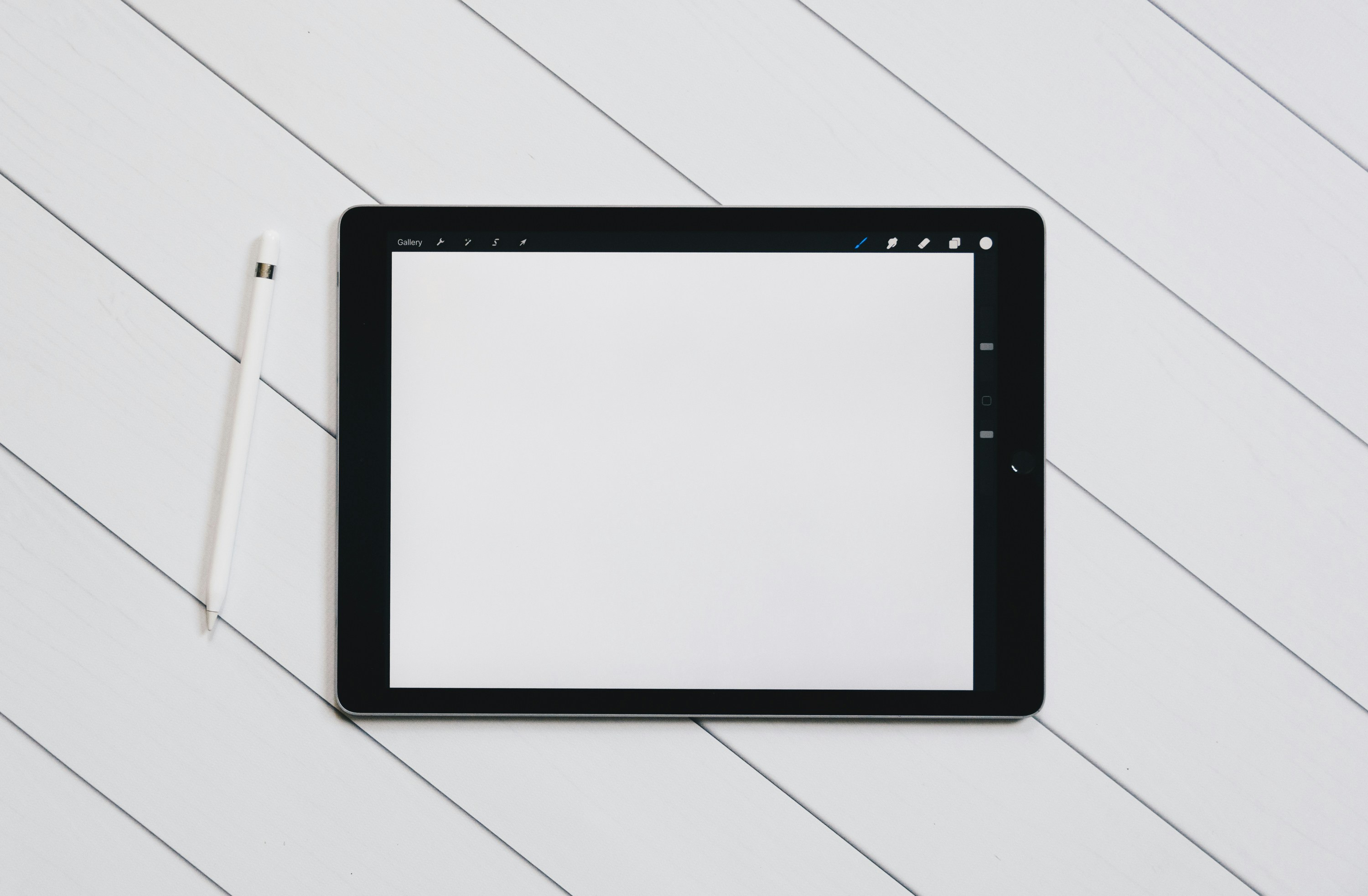 Close up of person using a tablet to drag and drop elements on a website builder