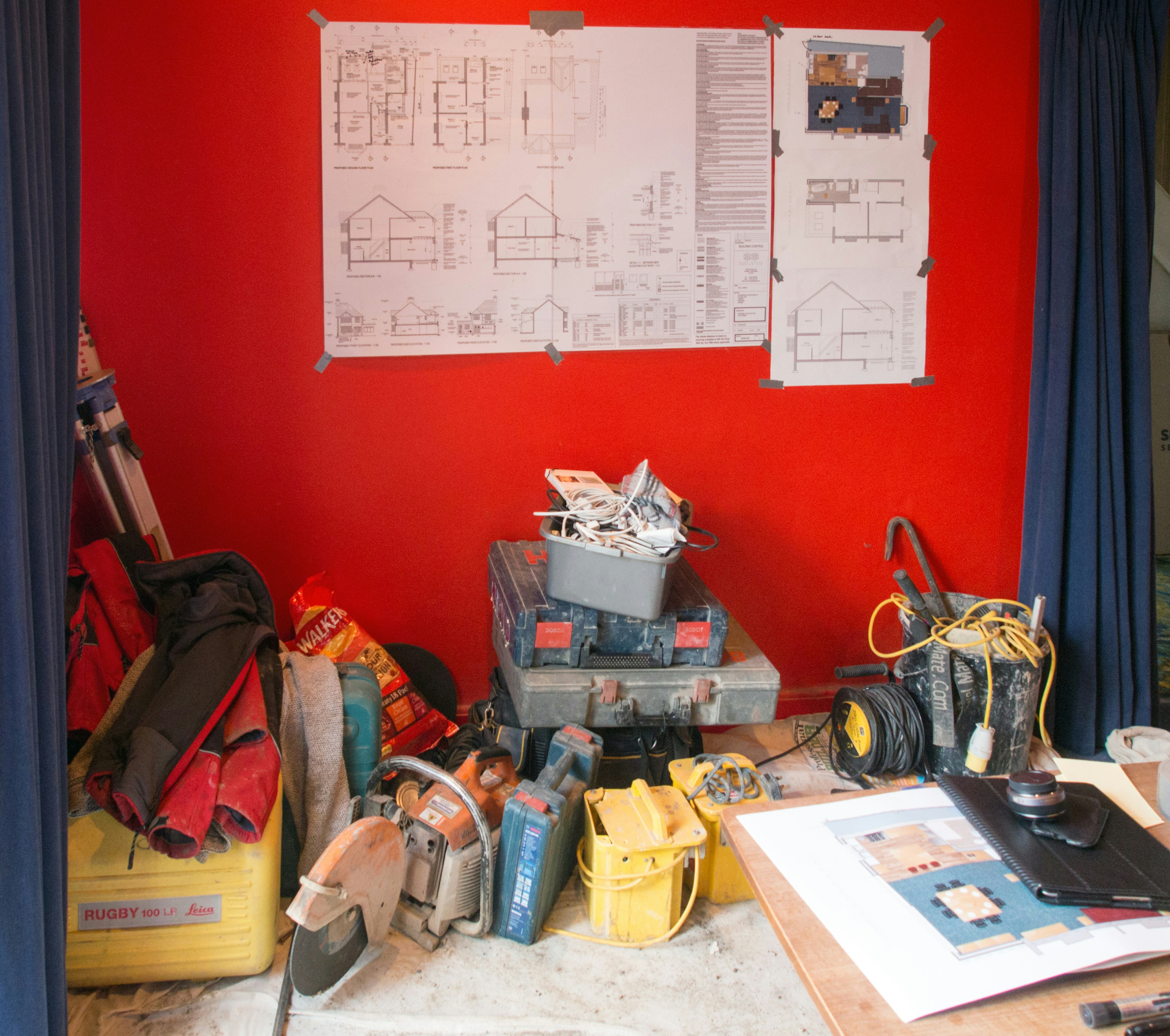Construction blueprints and plumbing tools on a table