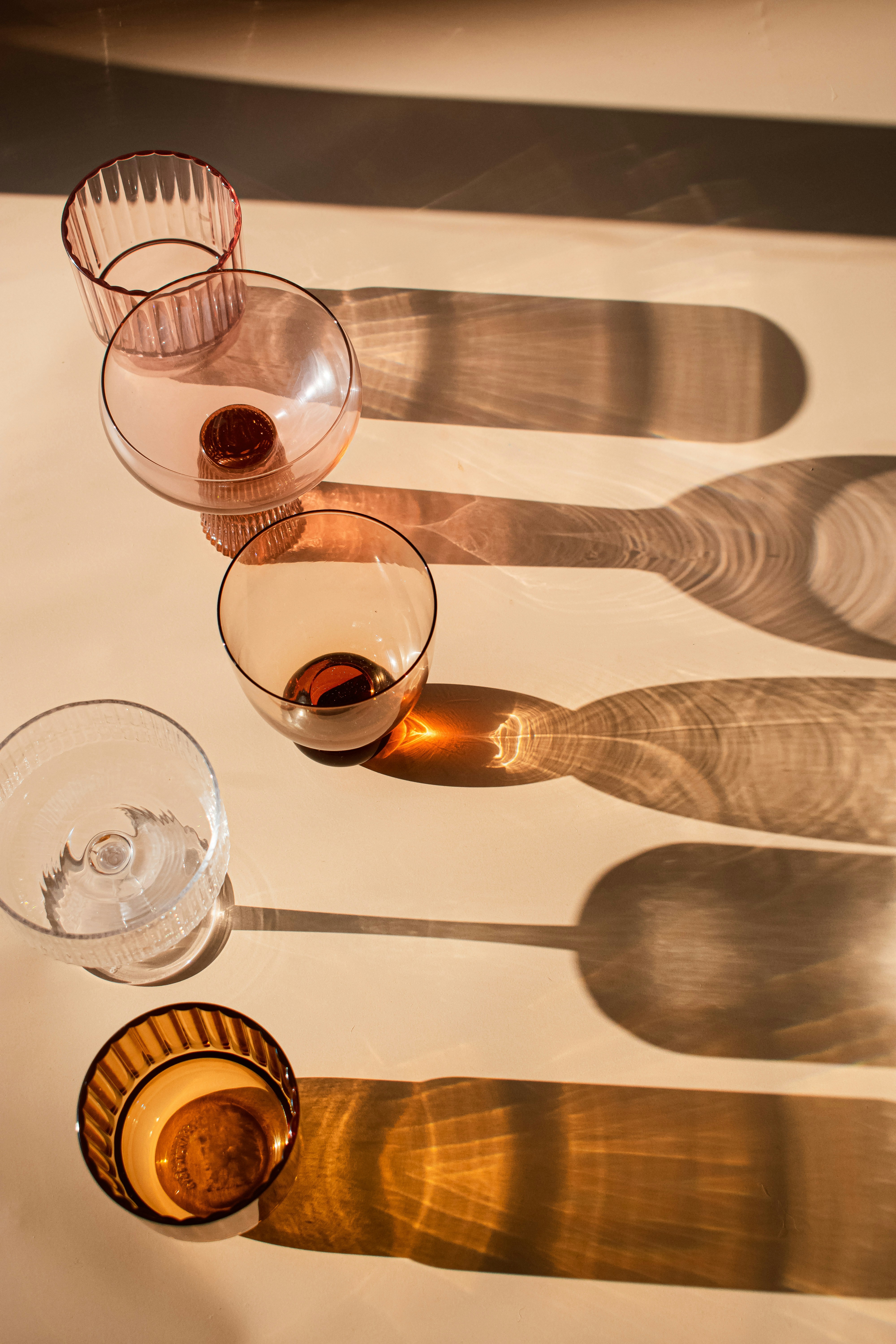 Close up of wine glasses filled with red and white wine on a wooden barrel during a tasting event