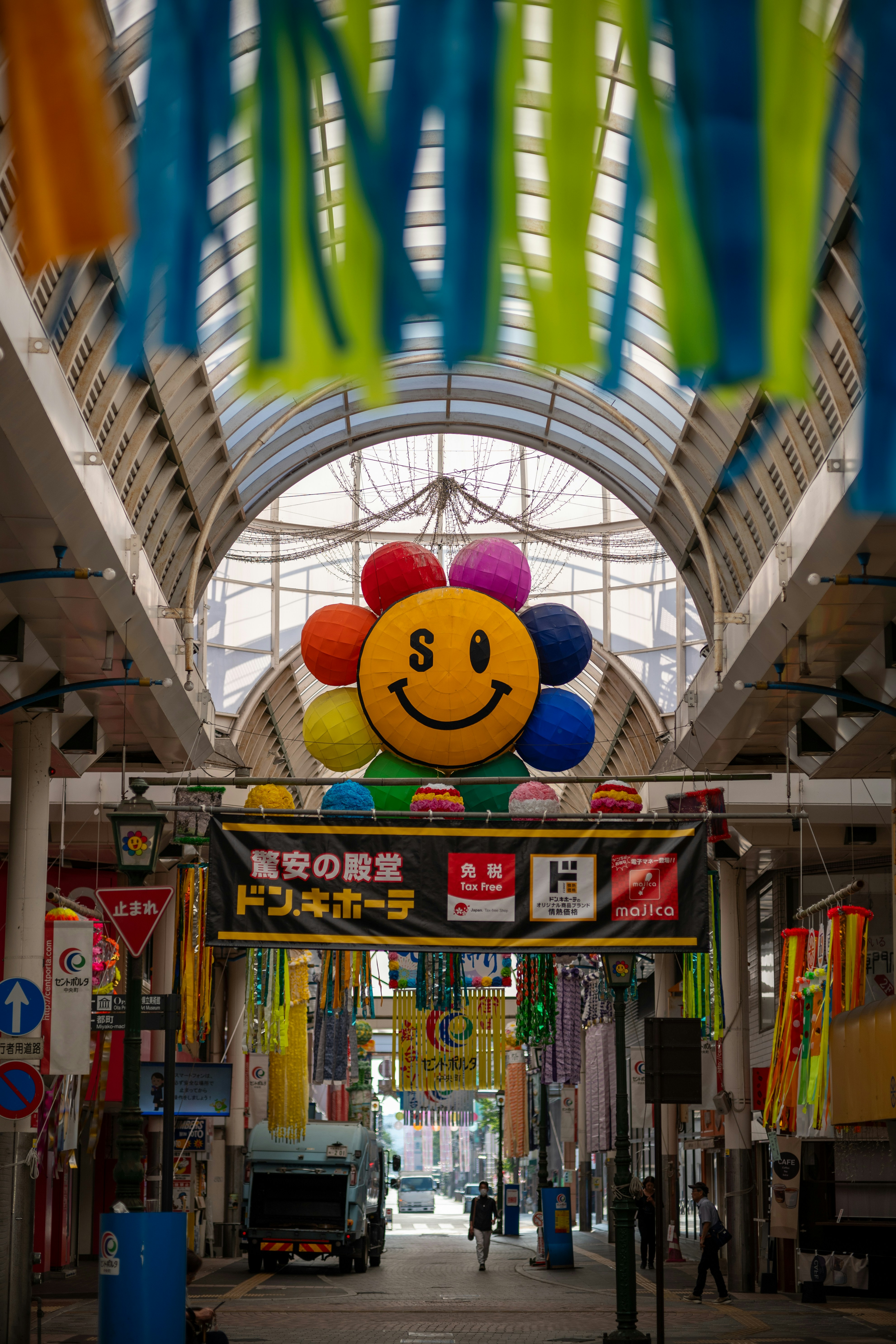Happy people carrying colorful shopping bags walking in a bright shopping mall corridor