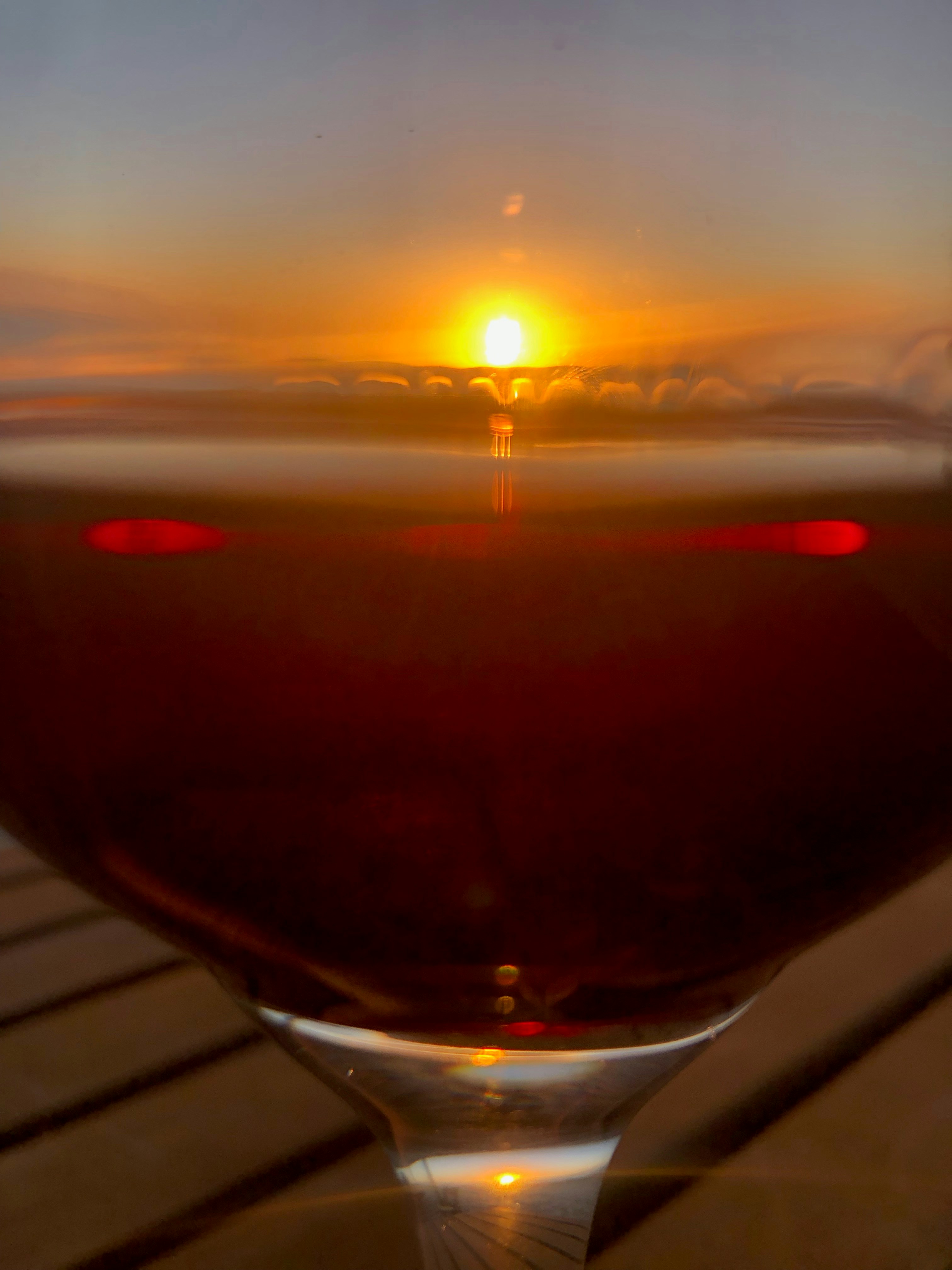 Close up of a glass of wine on a wooden table in a cozy bar atmosphere