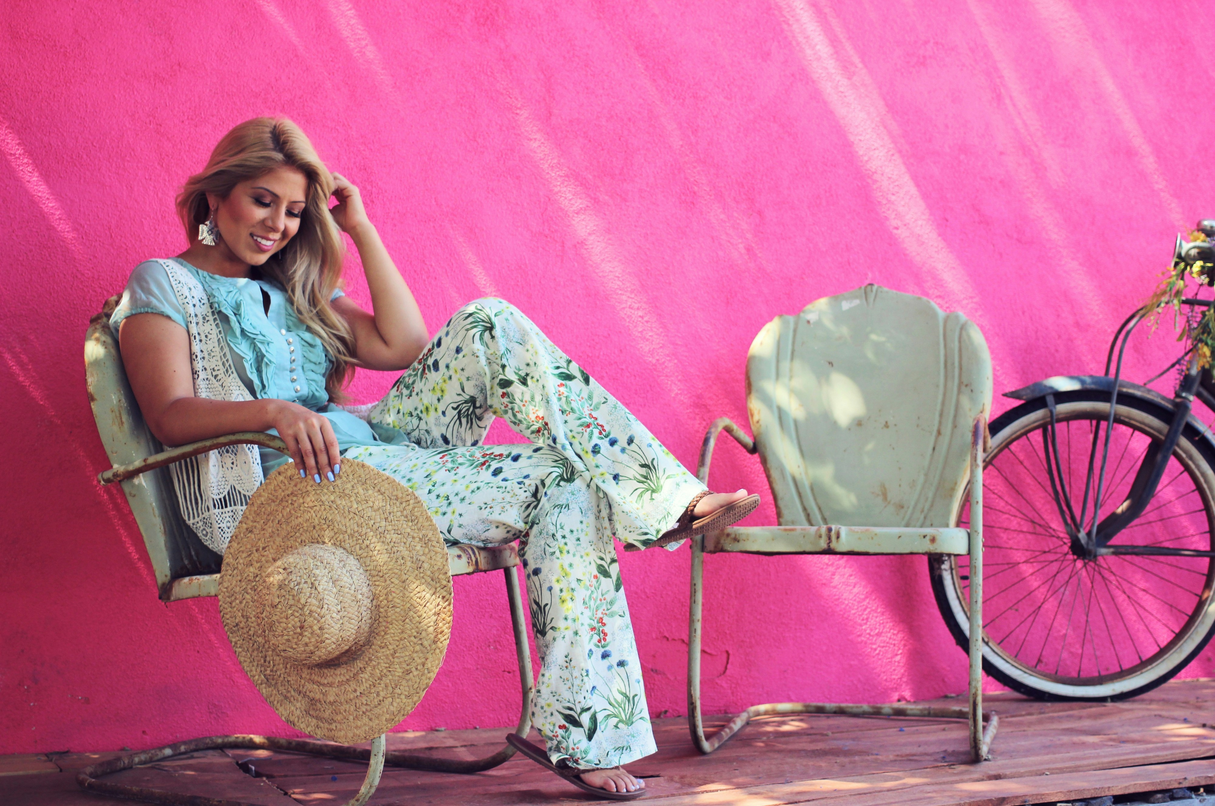 Woman laughing on a couch wearing elevated loungewear looking comfortable and chic