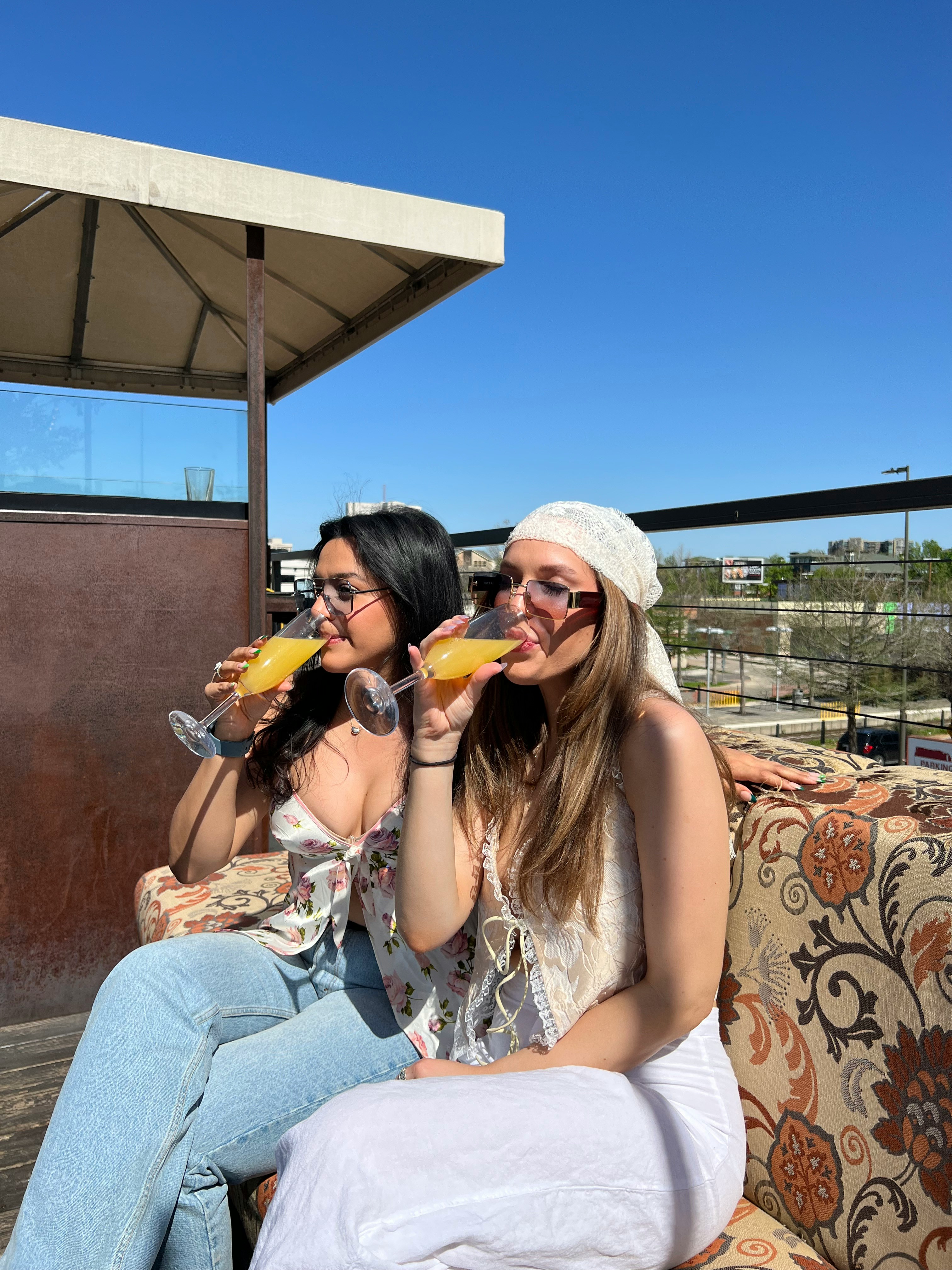 Friends toasting with beer glasses in a bar, happy faces, bokeh background