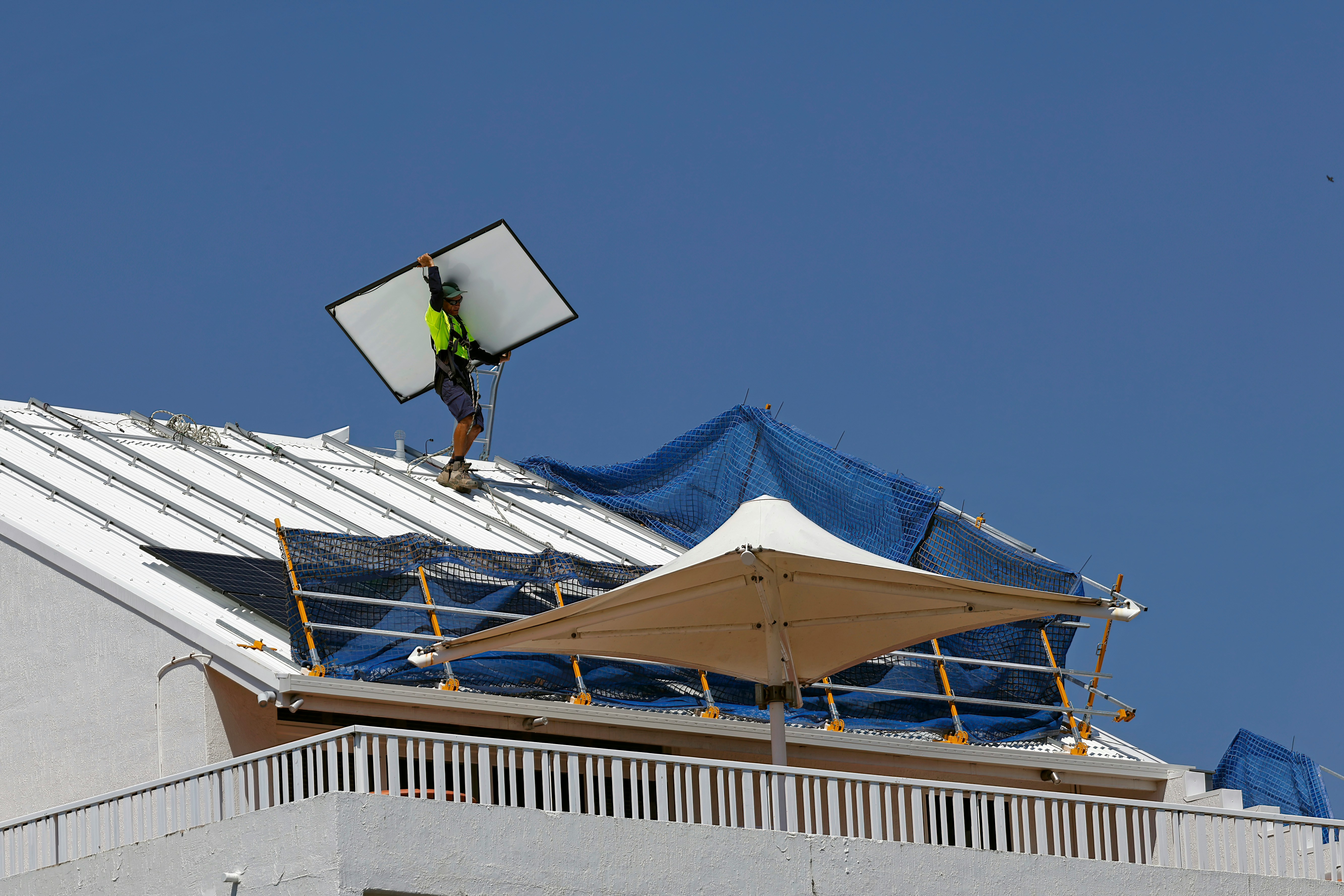 Close up of a worker applying external insulation on a facade, high details on the material texture