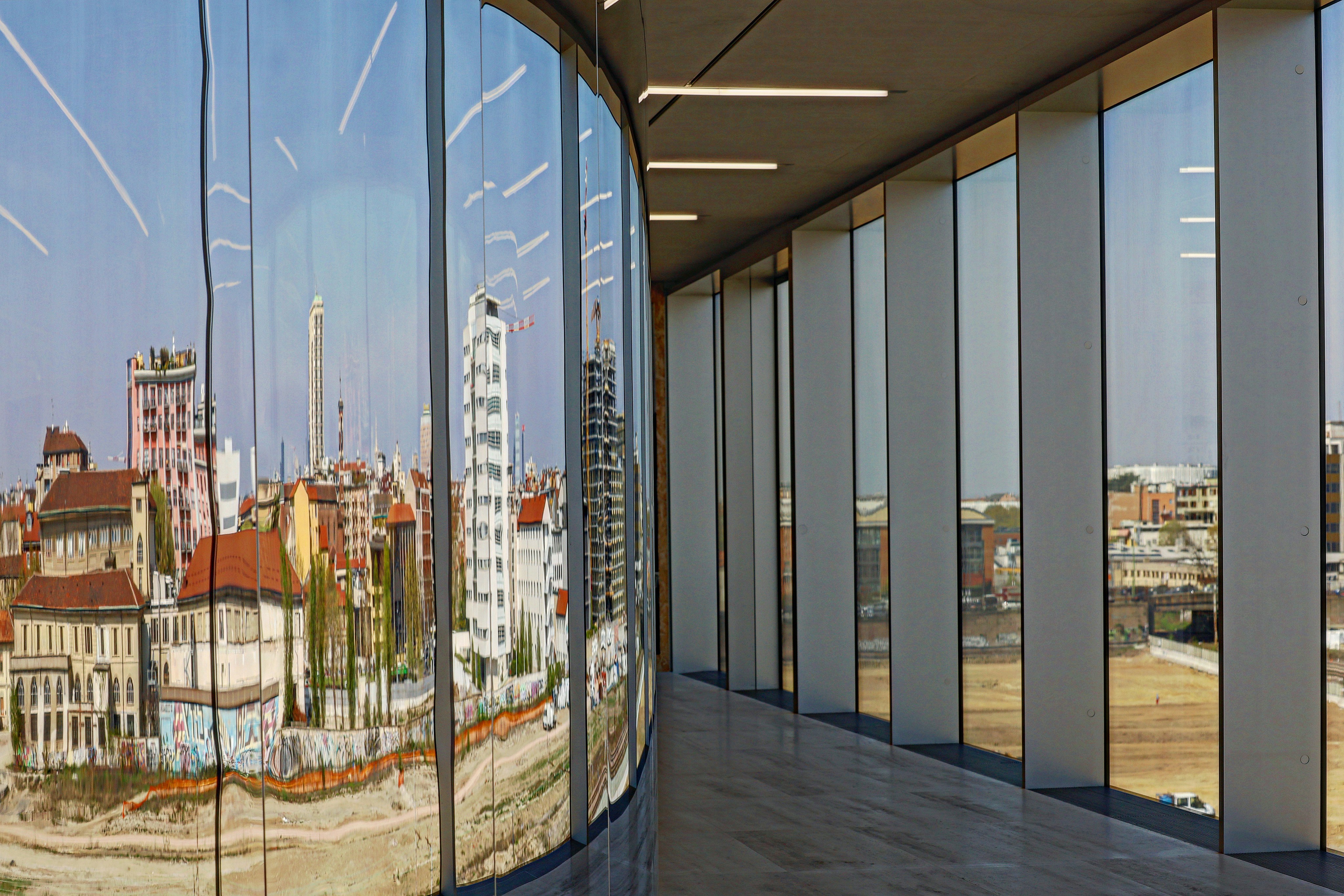 Business meeting in a modern Swiss office with marketing charts on a glass wall