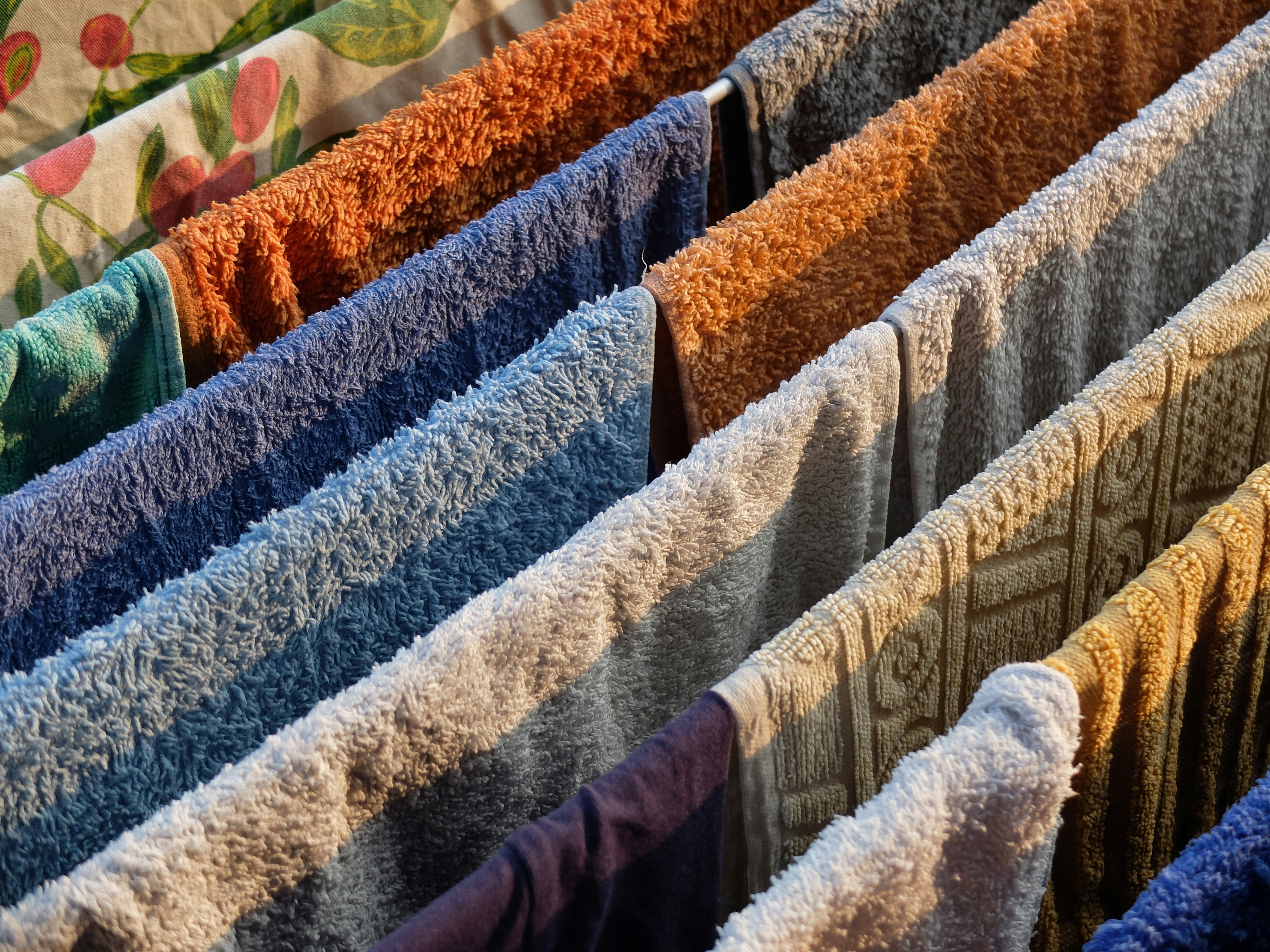 Close up of diverse natural fabrics piled up : linen, cotton, wool in earthy tones aiming for a aesthetic california vibe