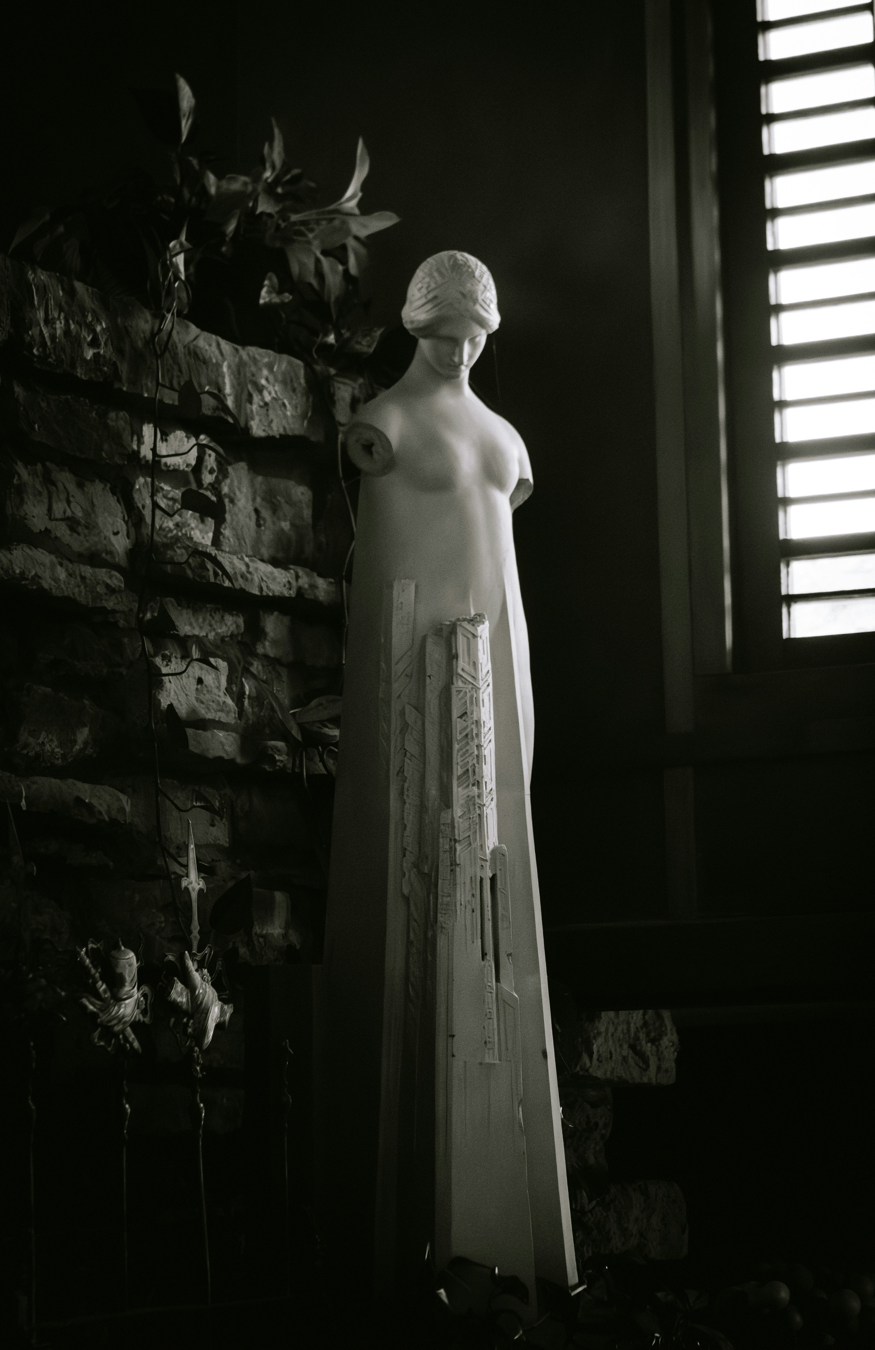 Close up shot of stacked fashion books on a wooden table with a blurred background of a bright living room.