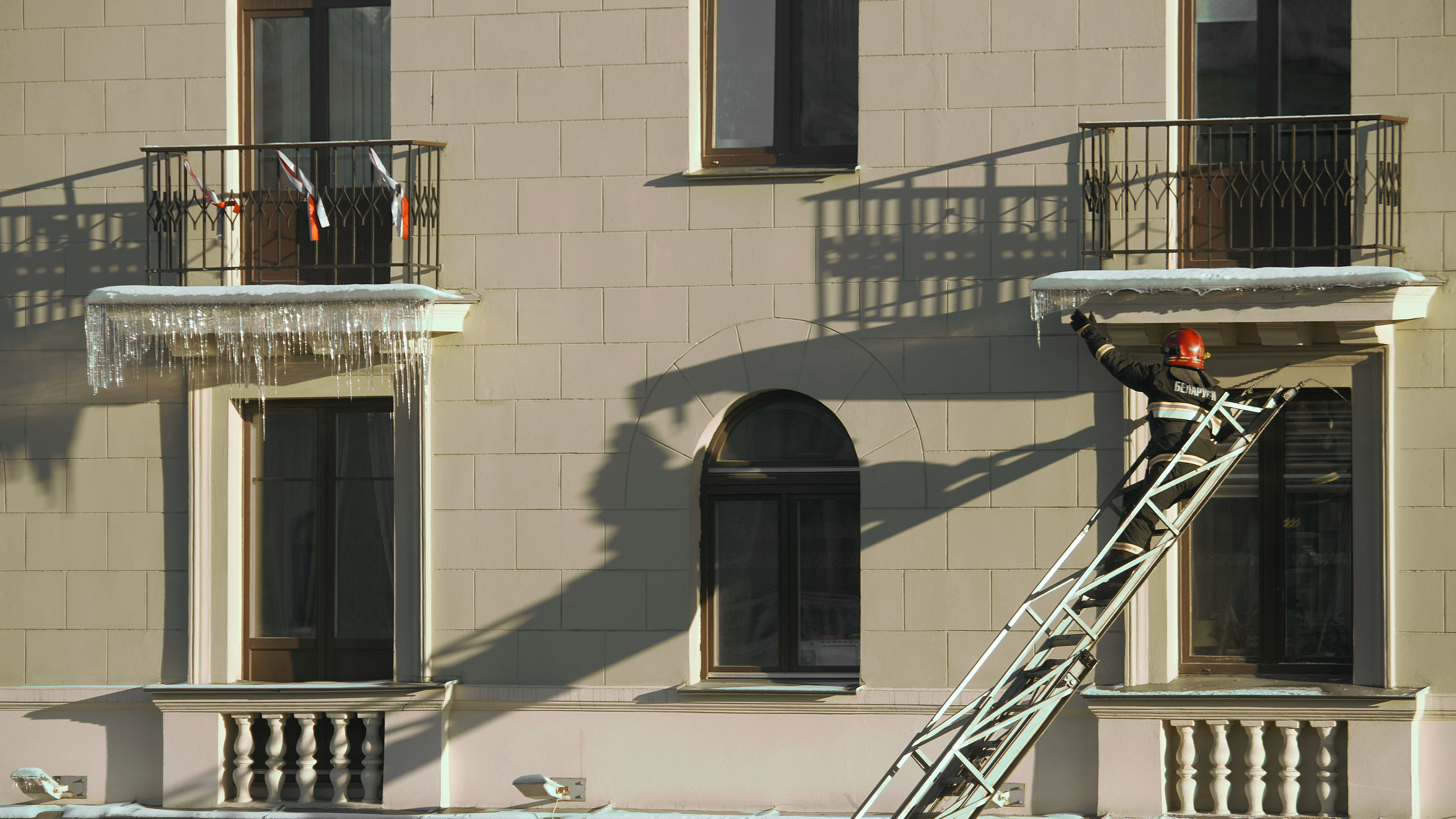 Worker installing a sun awning on a balcony with professional tools
