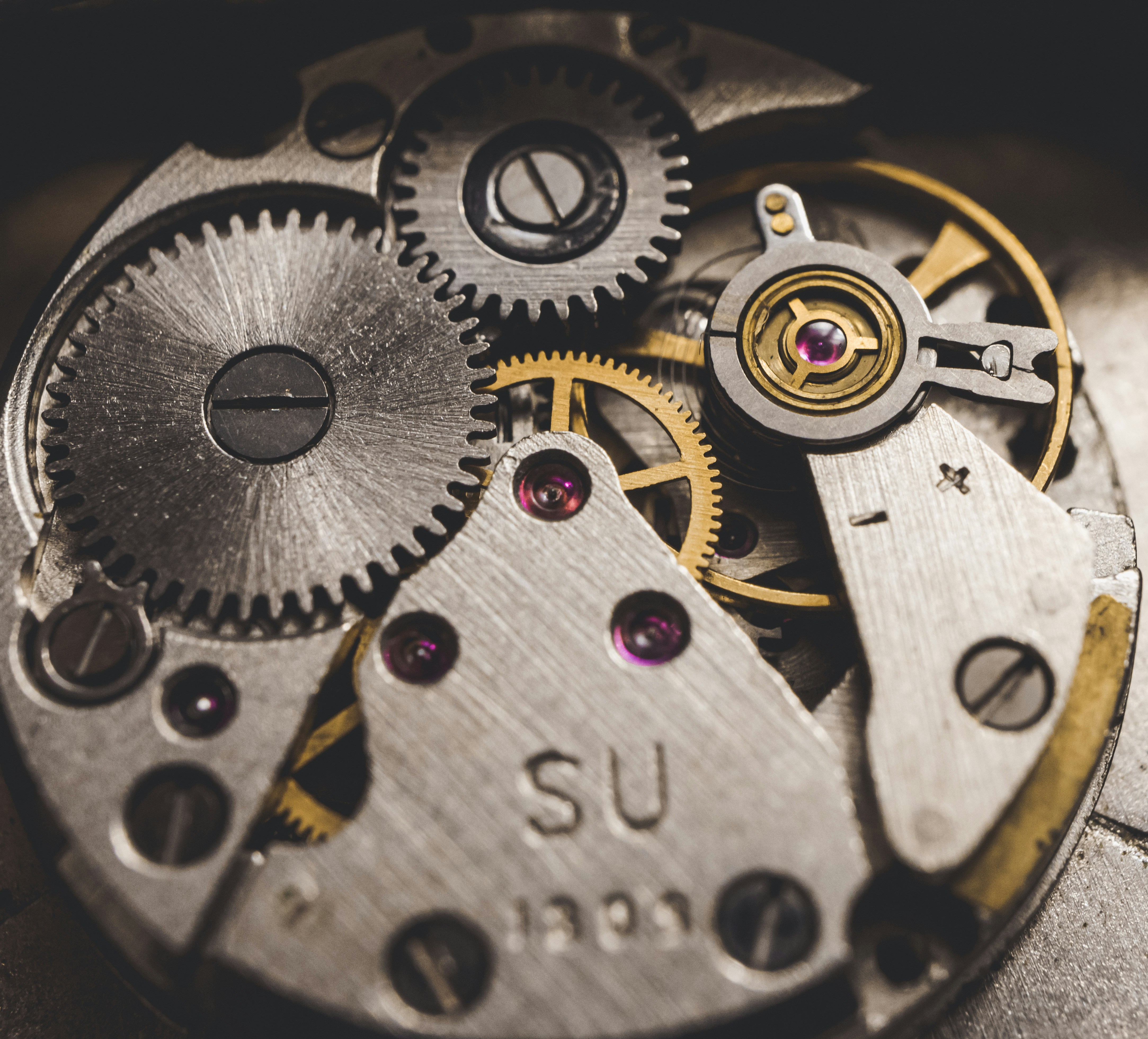 Close up of a swiss watch mechanism emphasizing precision and complexity