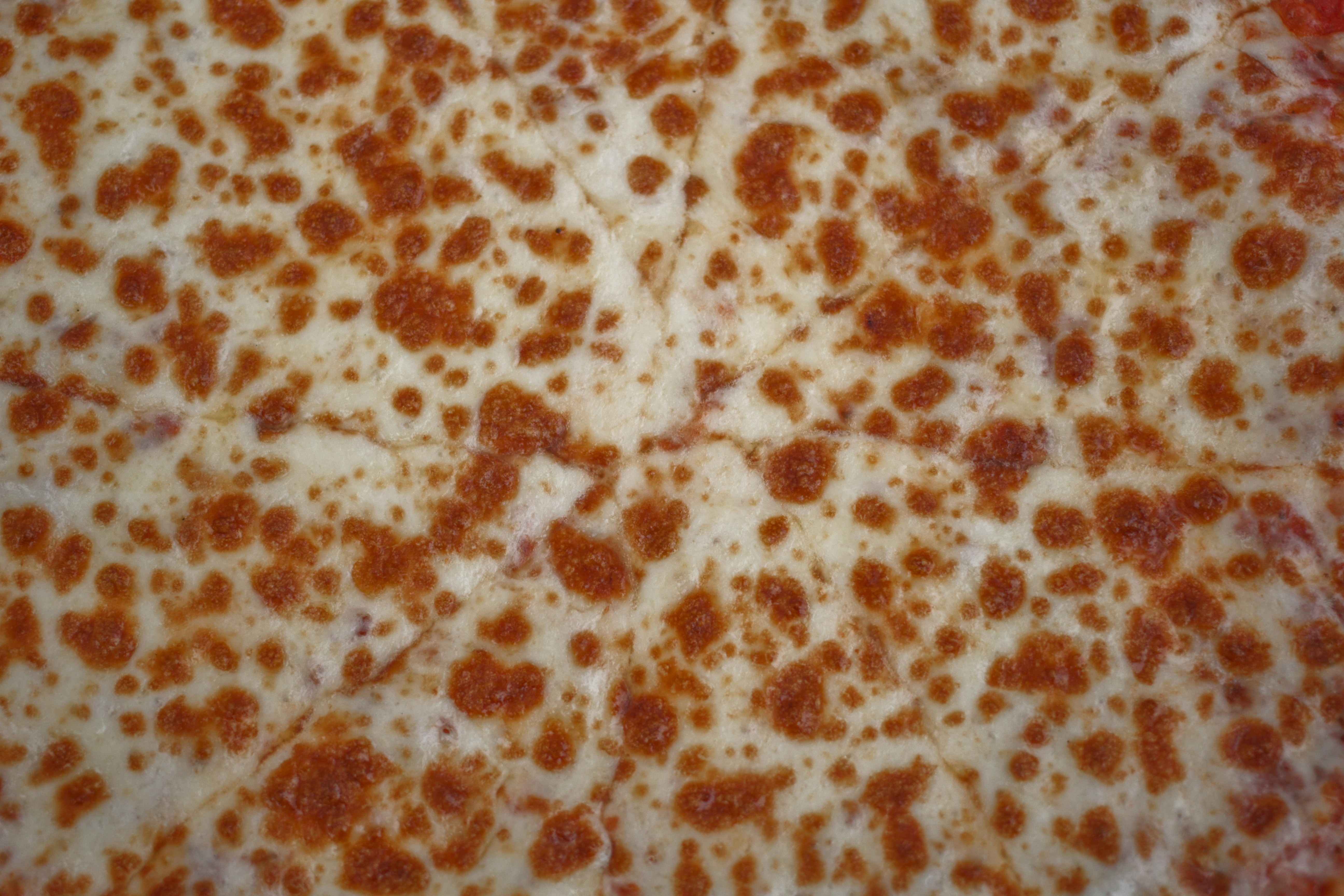 Close up of a delicious pepperoni pizza with cheese pull