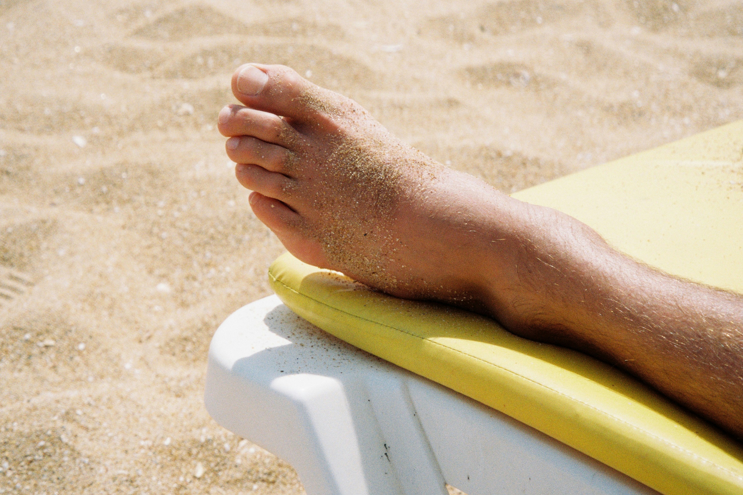 Close up of hands gently holding a patient's ankle during a myofascial release session, soft lighting, professional atmosphere.