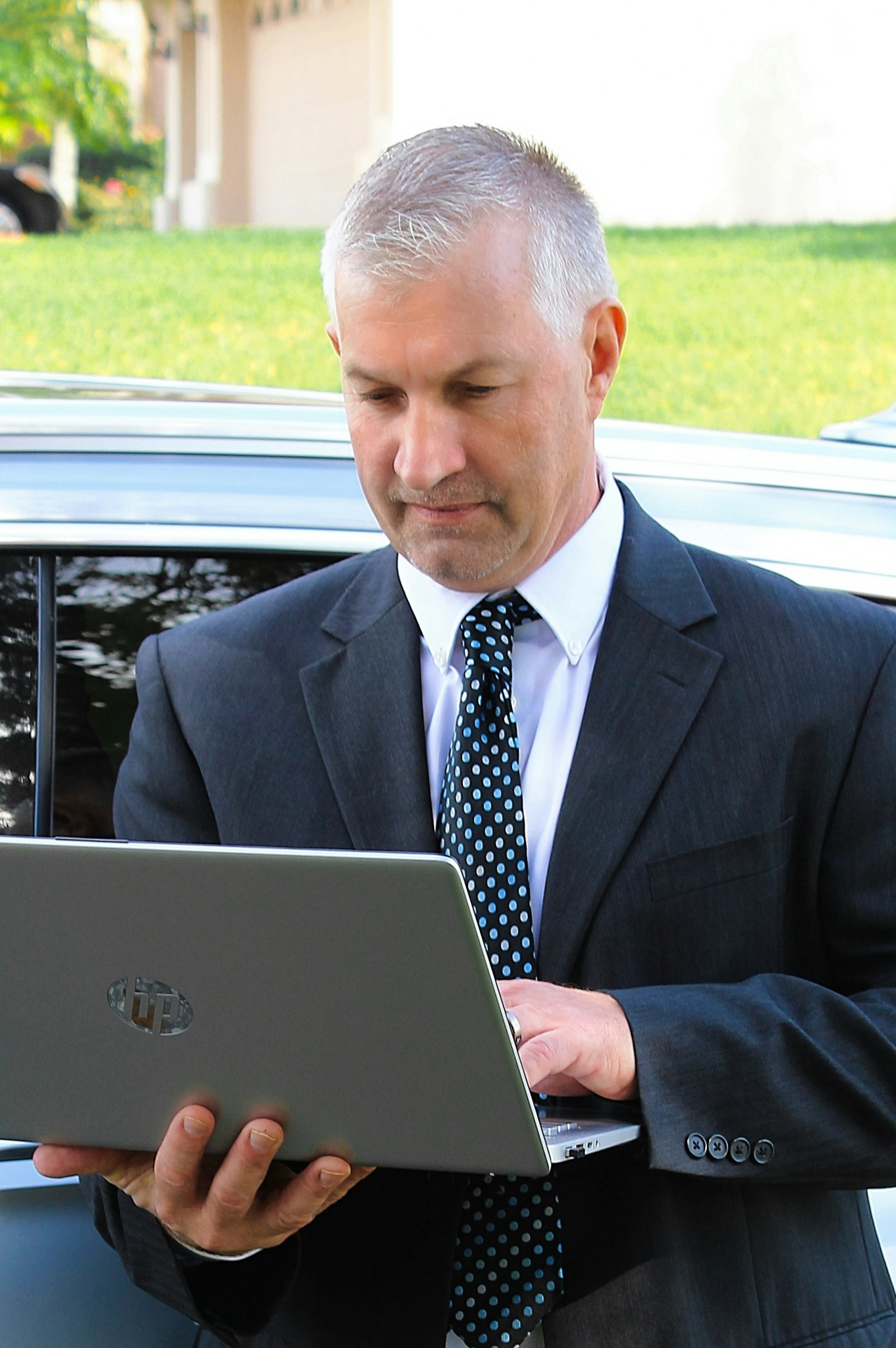Business professional looking concerned while analyzing data on a tablet