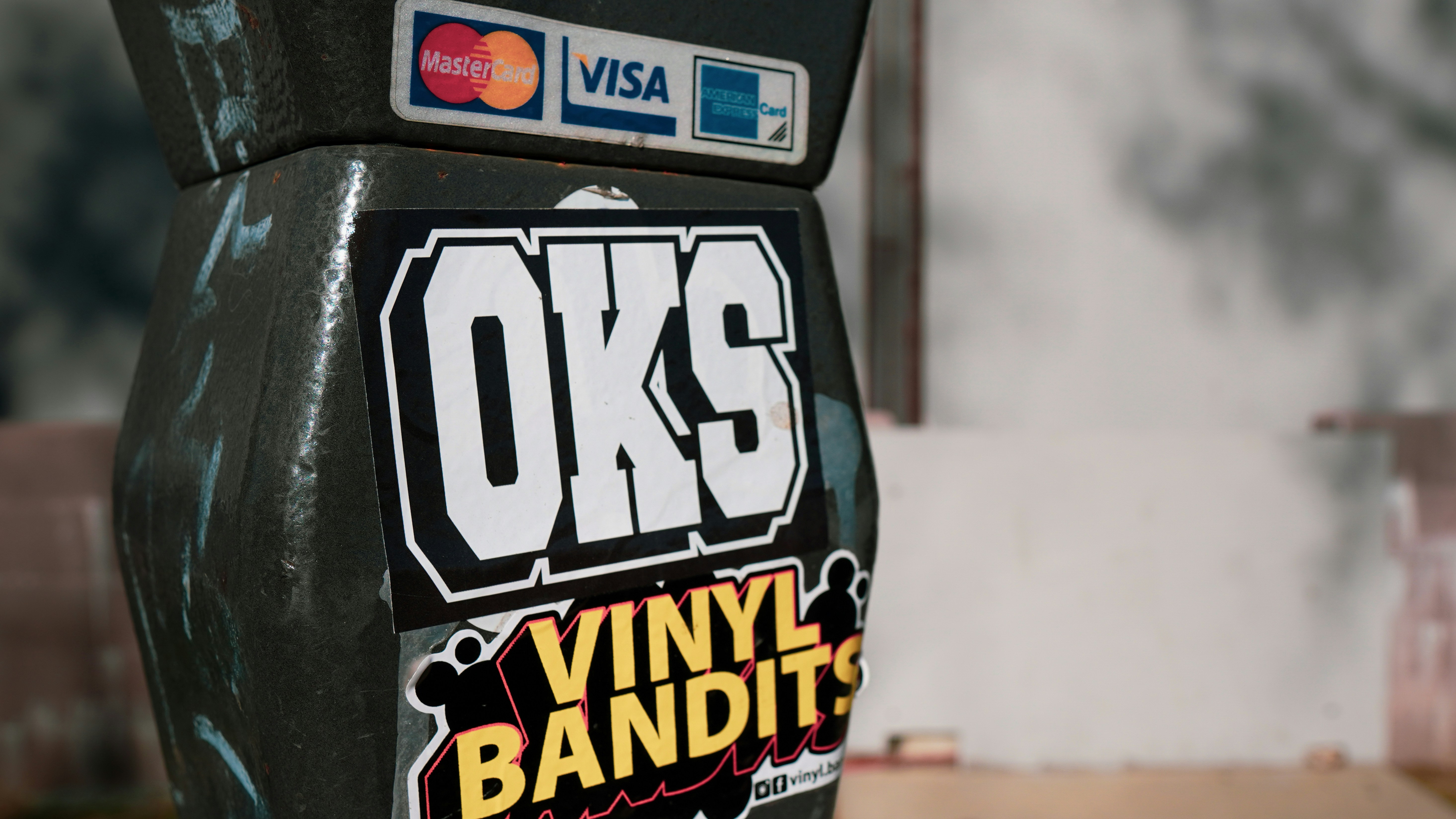 Close up of a band's merchandise table with a sign saying Scan to Support with a QR code