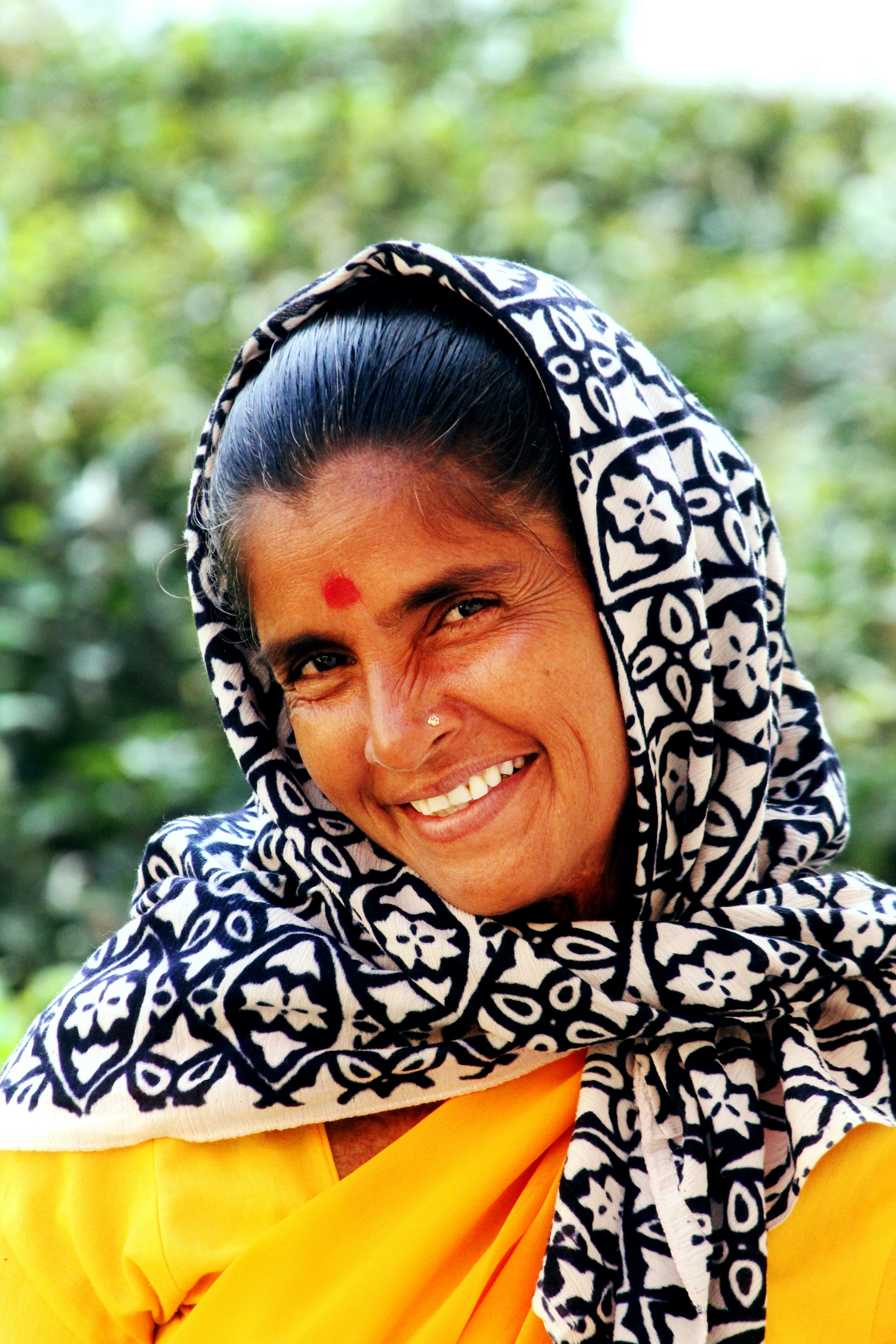 Happy woman looking at her phone screen after successfully making a donation via QR code