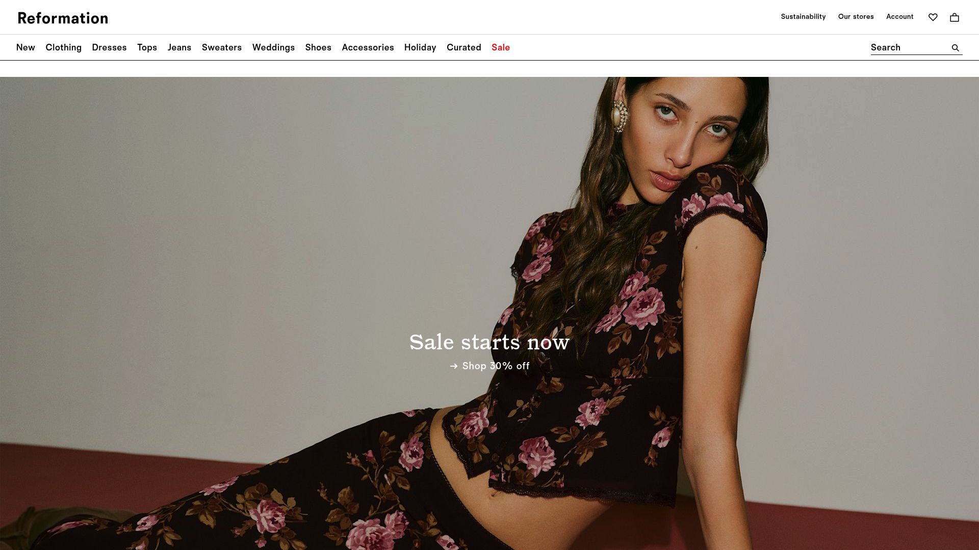 Homepage of Reformation website showing models in floral dresses