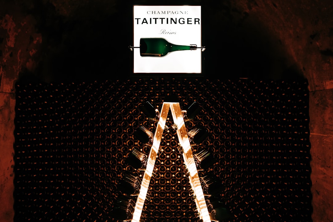 taittinger - a large bottle of wine sitting on top of a metal rack