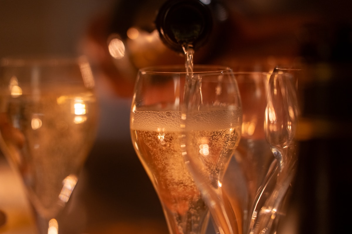 Verres de champagne remplis de bulles dorées dans un environnement chaleureux.
