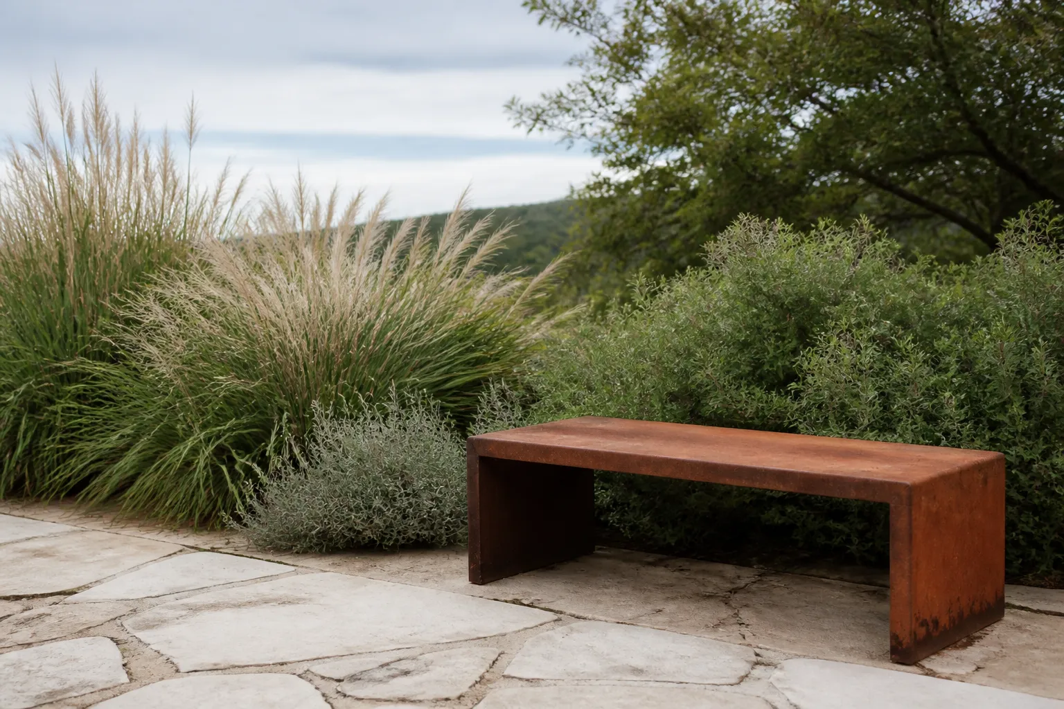 Banc en bois rustique sur terrasse de pierre entourée de végétation.