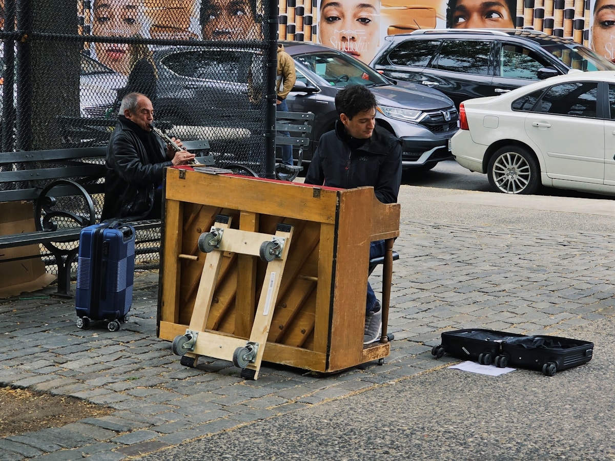 a man sitting on a bench next to a wooden box