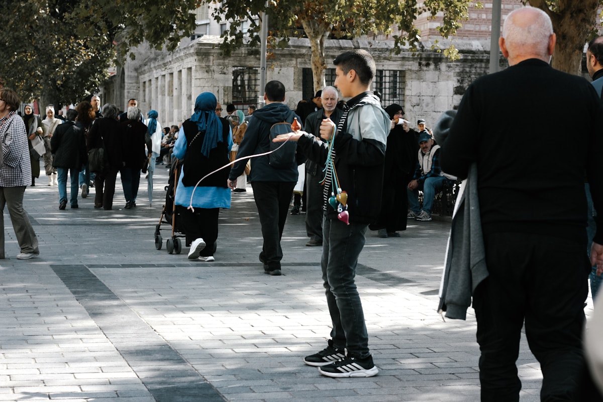 A young man practices rope skipping outdoors.