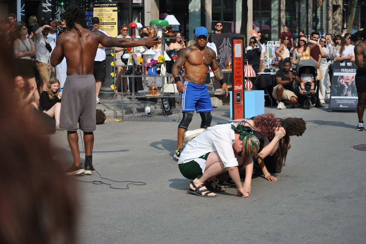 Street performers are entertaining a large crowd.