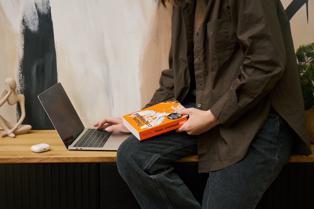 a person sitting on a table with a laptop