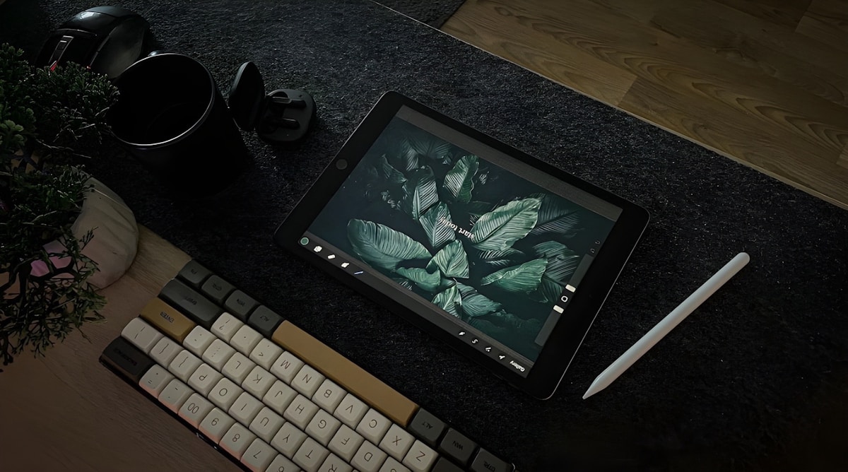 A computer monitor sitting on top of a desk next to a keyboard